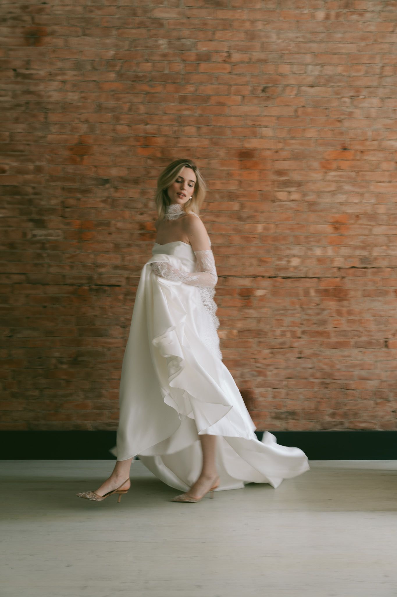 Artistic series of a wedding dress movement against rustic brick backdrop in New York City