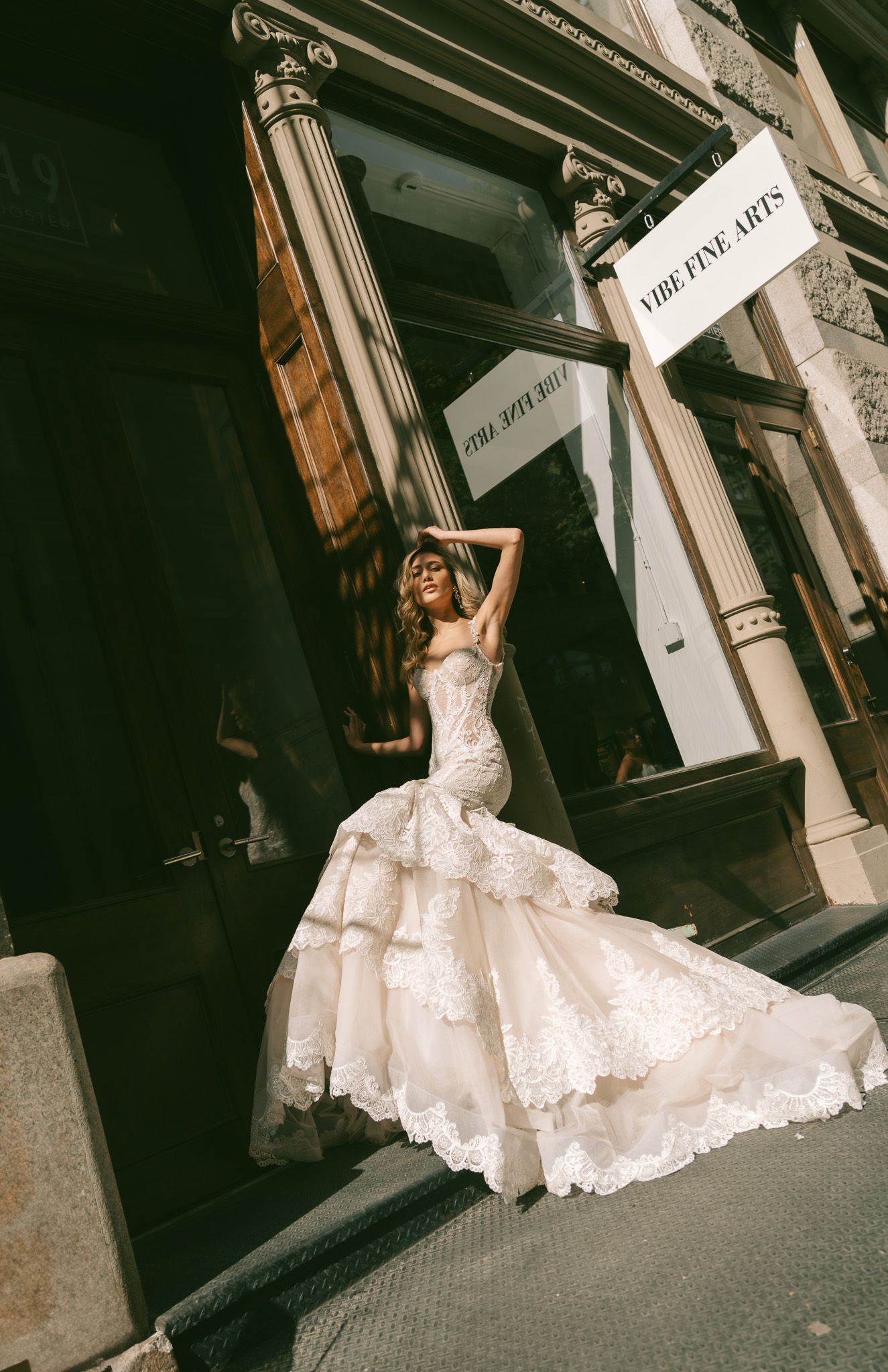 Dramatic Galia Lahav lace wedding gown with fitted bodice and flared skirt photographed in the streets of Soho New York City.