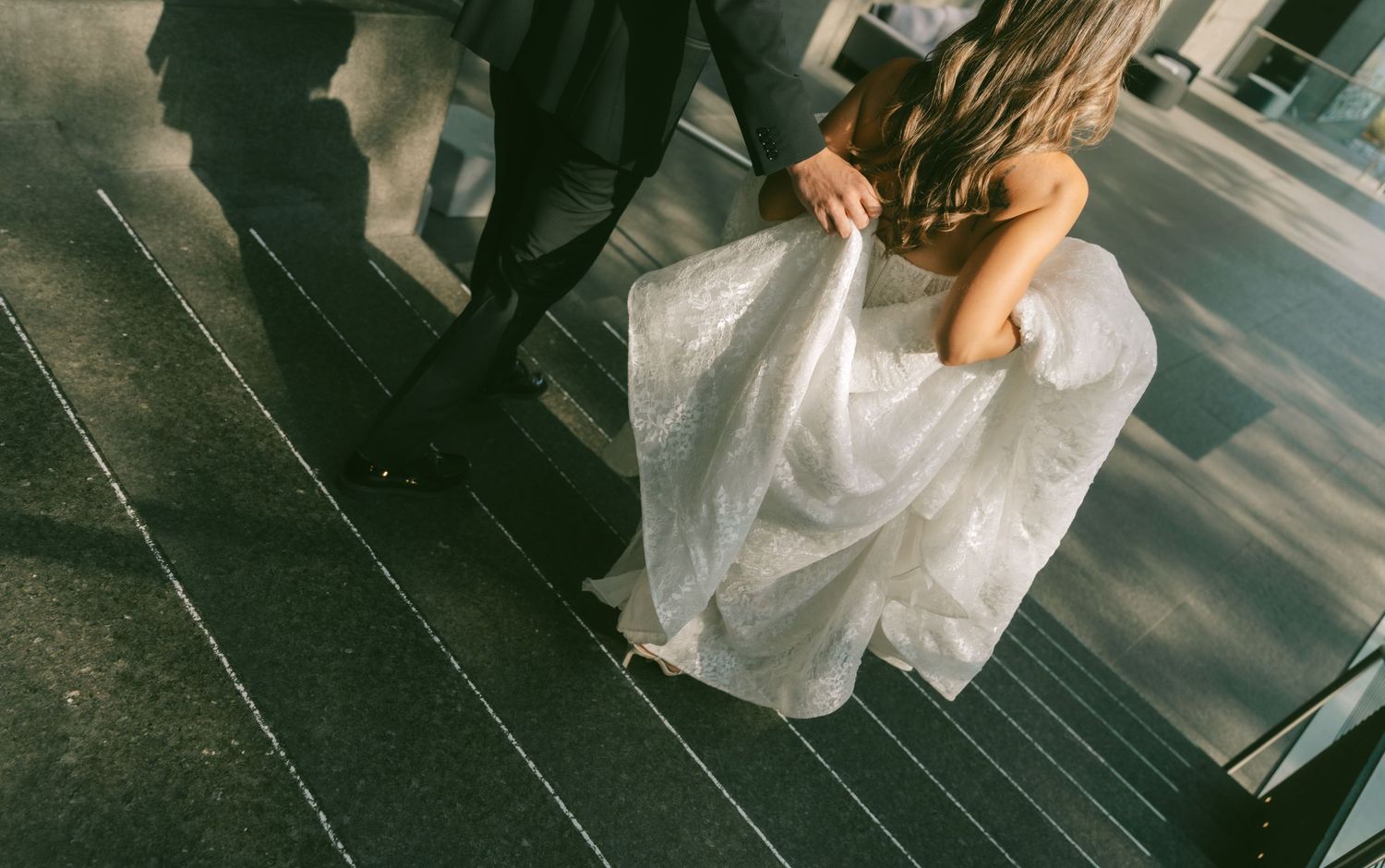 Romantic dance sequence between bride in flowing white dress and groom in dark suit.