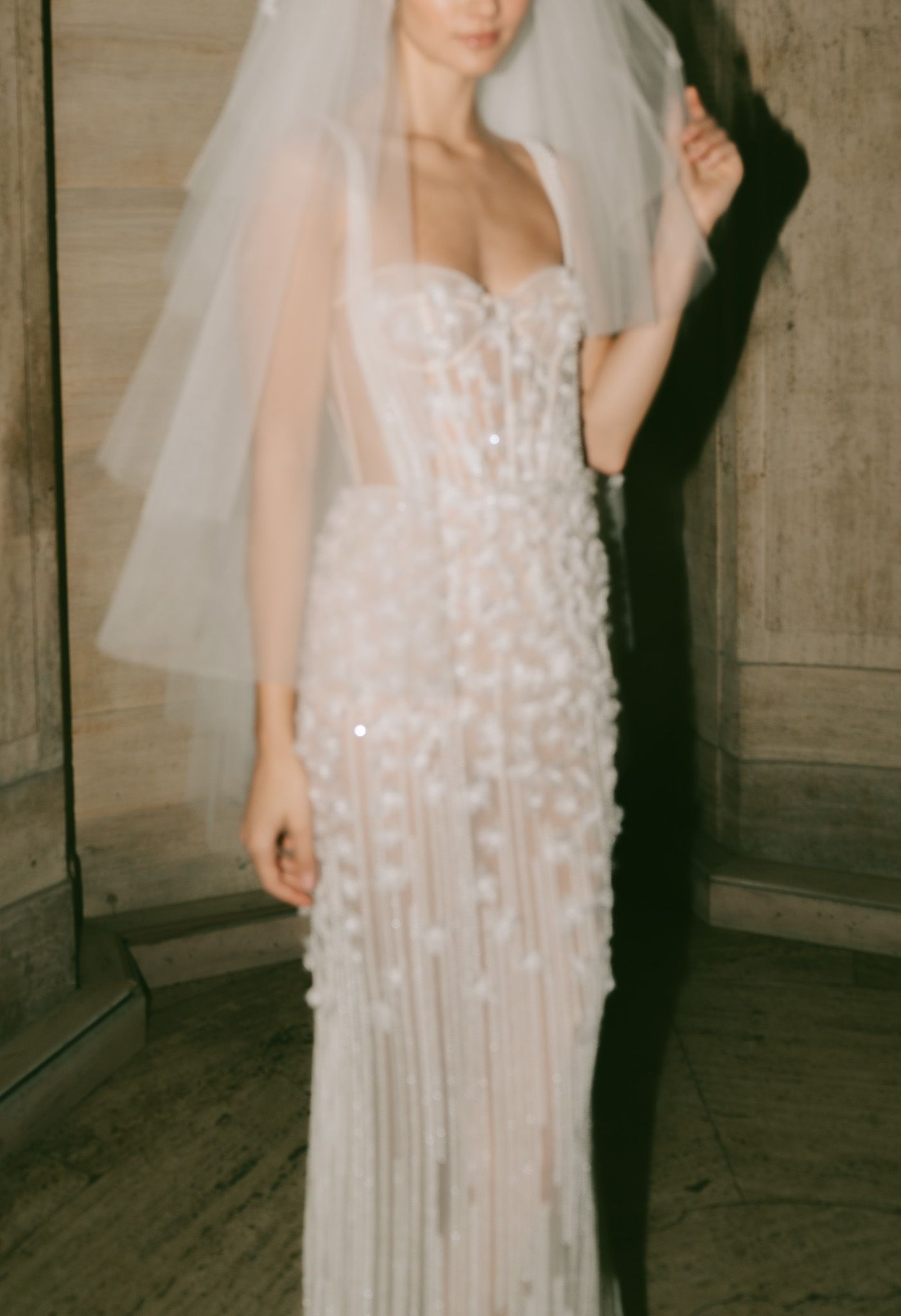 Elegant Berta bridal gown with sheer overlay and crystal embellishments in an elegant space in NYC.