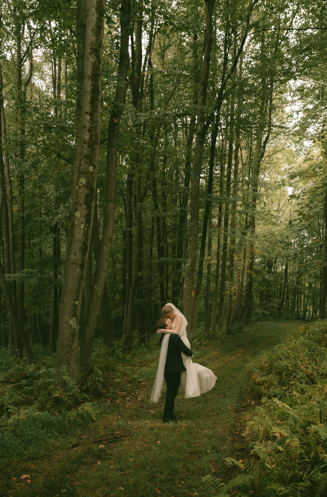 Wedding photo sequence in a lush forest setting with couple interacting among trees.