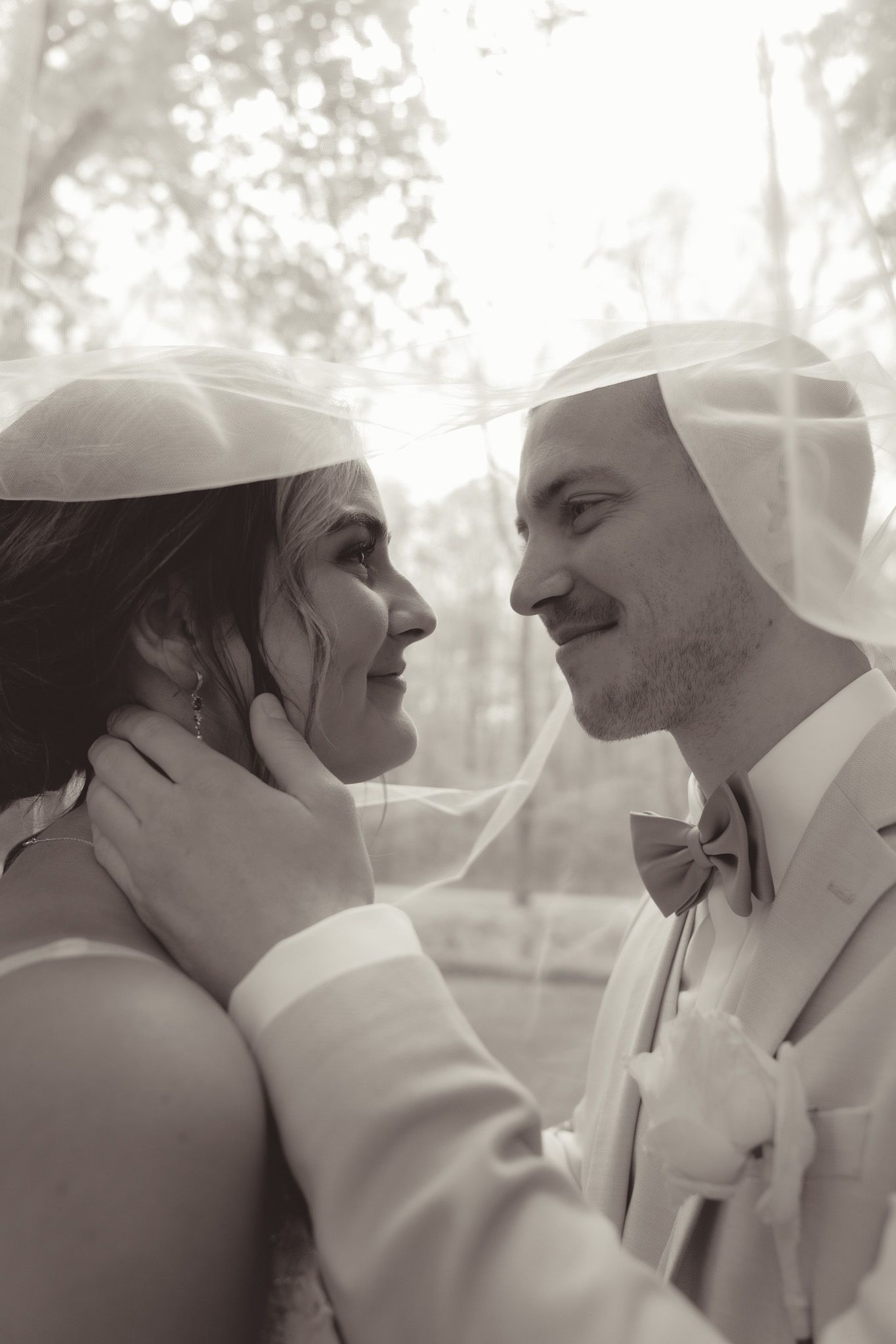 An intimate black and white wedding portrait showing tender moments between newlyweds in Germany.