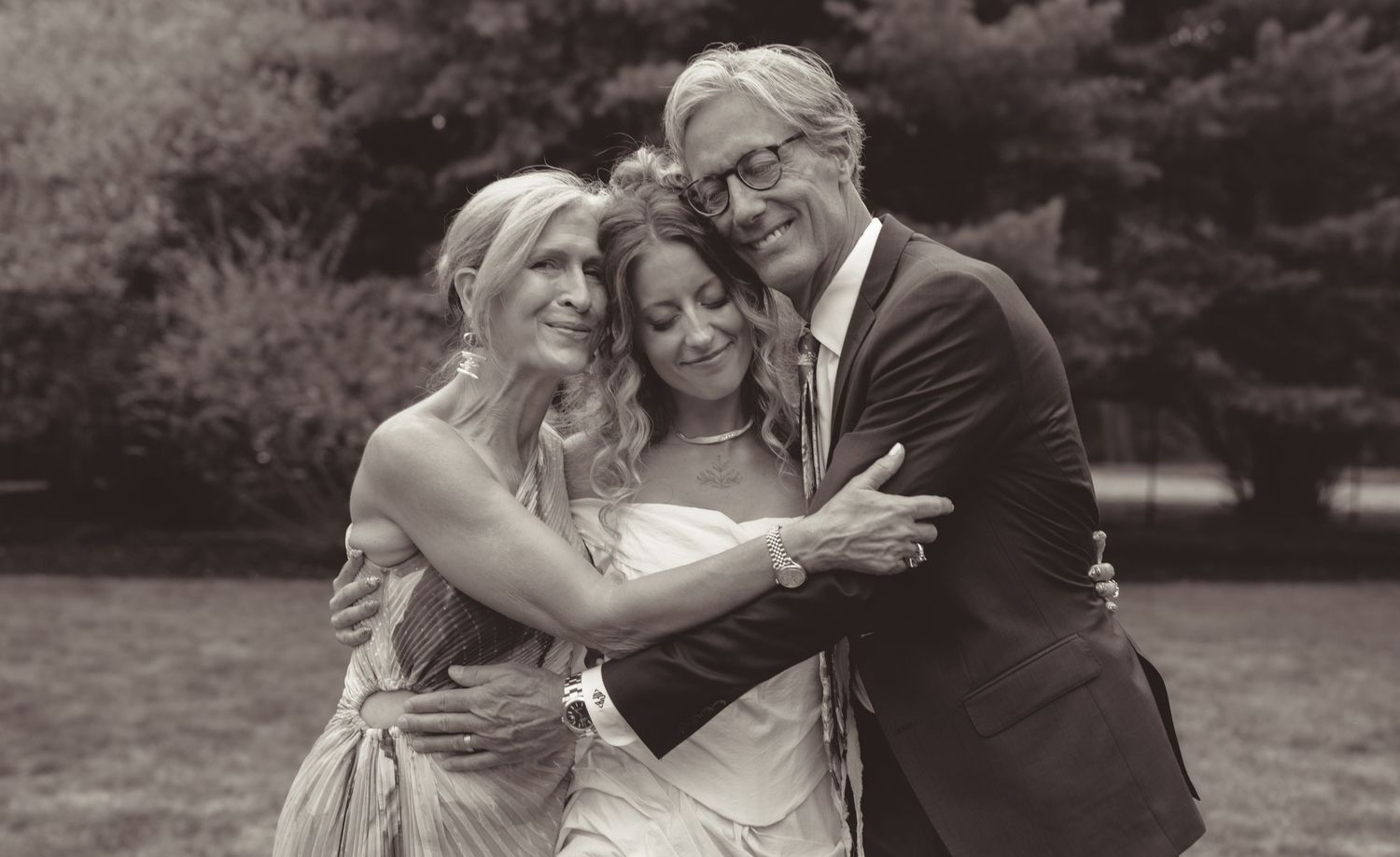 A series of black and white wedding photographs showing joyful moments between a couple and their loved ones during celebrations.
