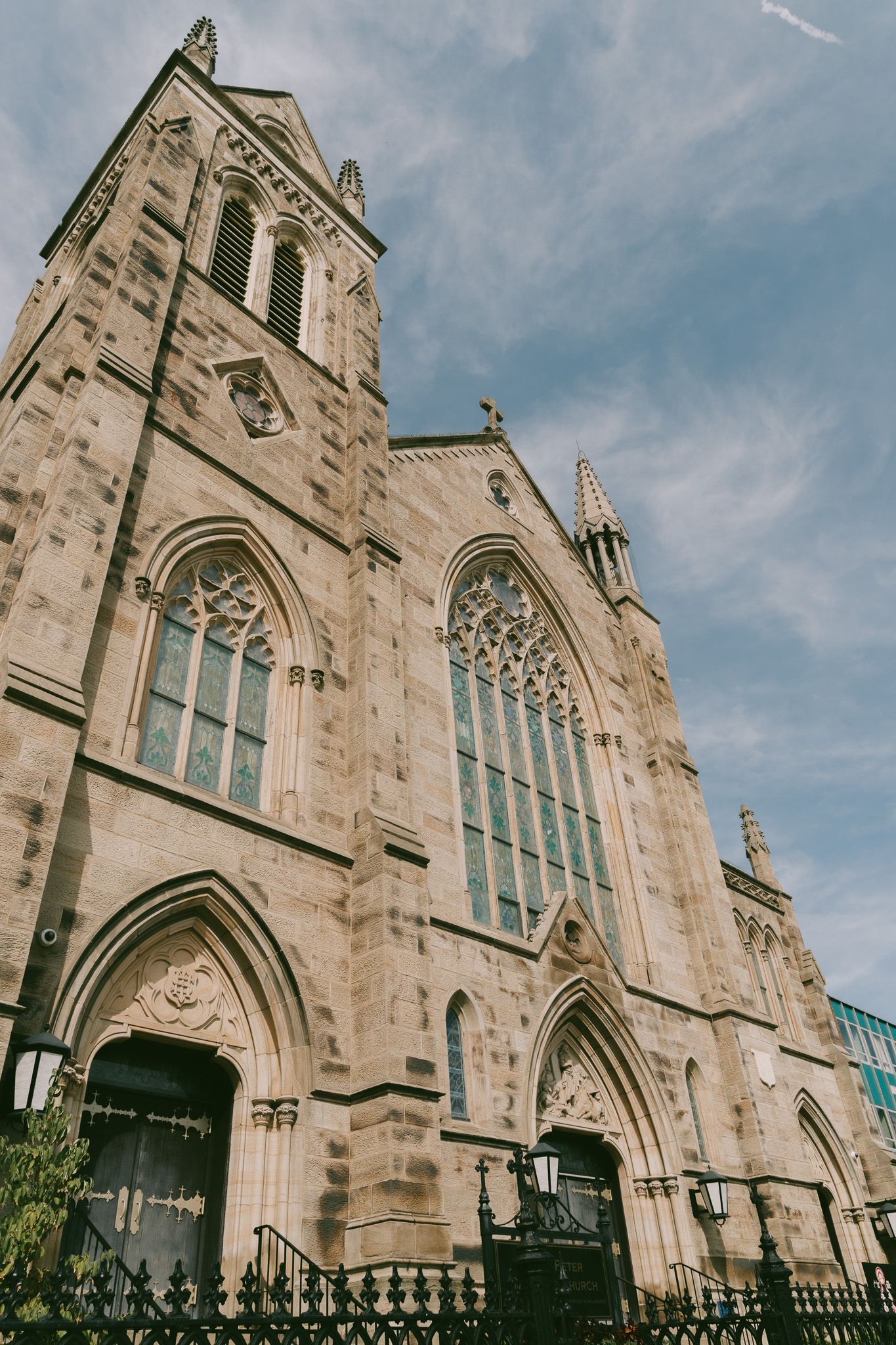 Gothic church exterior with ornate stone architecture and pointed arches against a blue sky in downtown pittsburgh, pa.