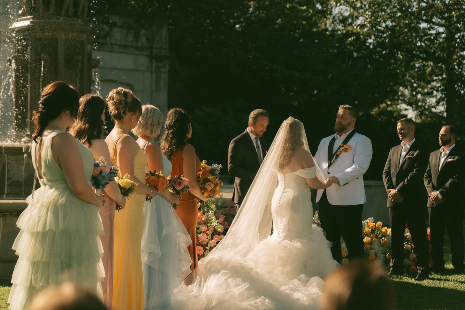 Wedding party standing outdoors in formal attire and yellow bridesmaid dresses in downtown pittsburgh, pa.