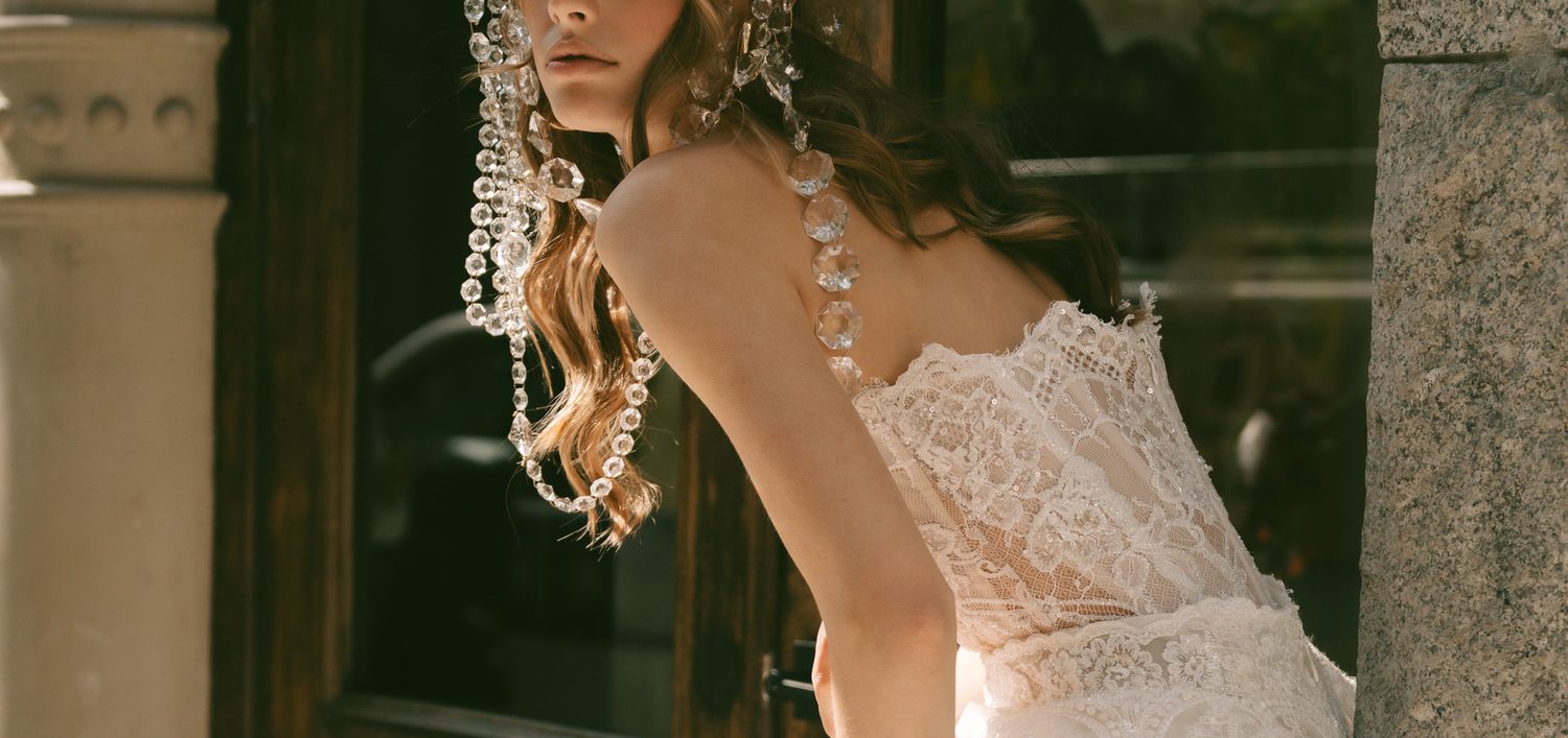 Detailed back view of Galia Lahav lace wedding dress with delicate head piece details.