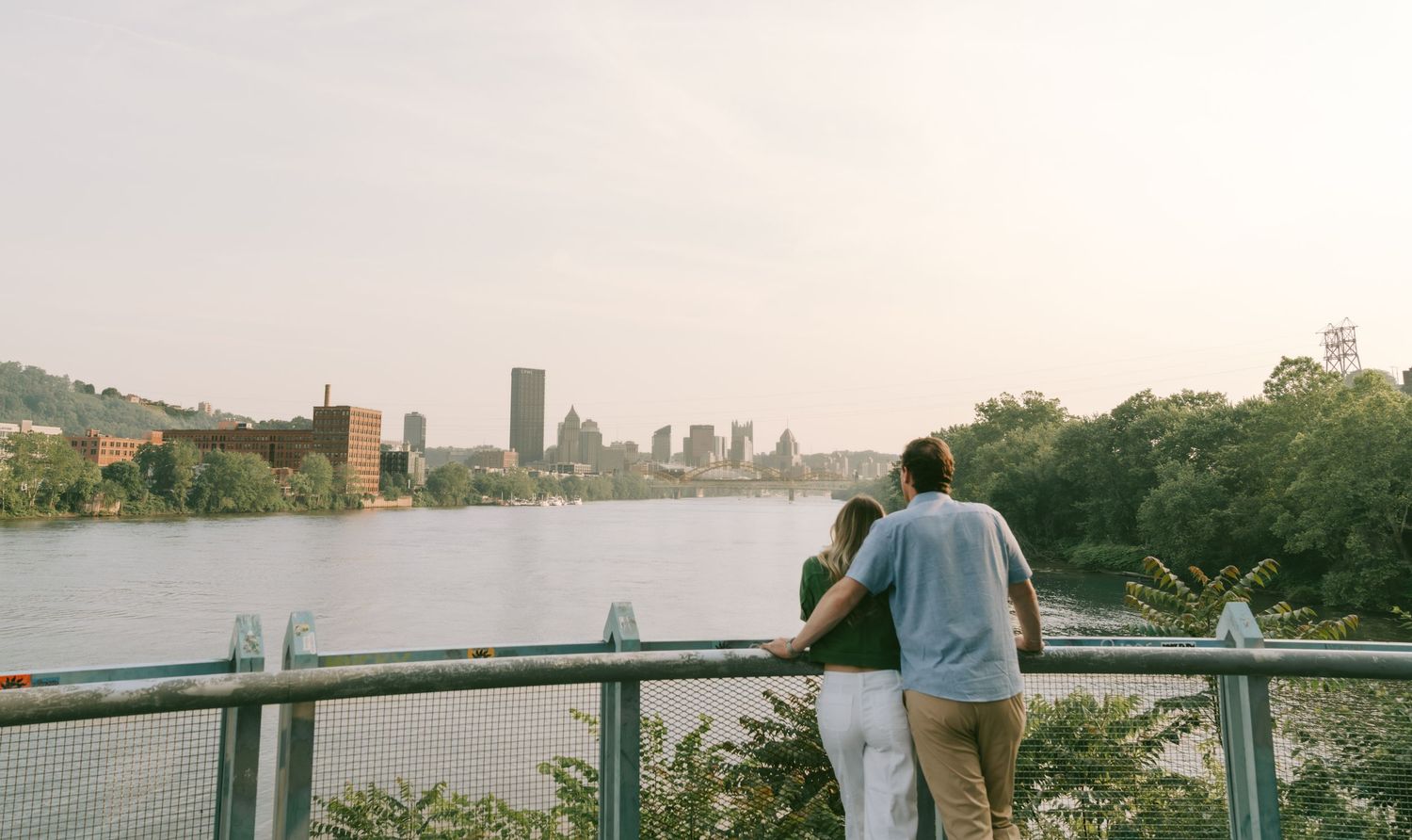 Panoramic cityscape view with waterfront and buildings in the distance.