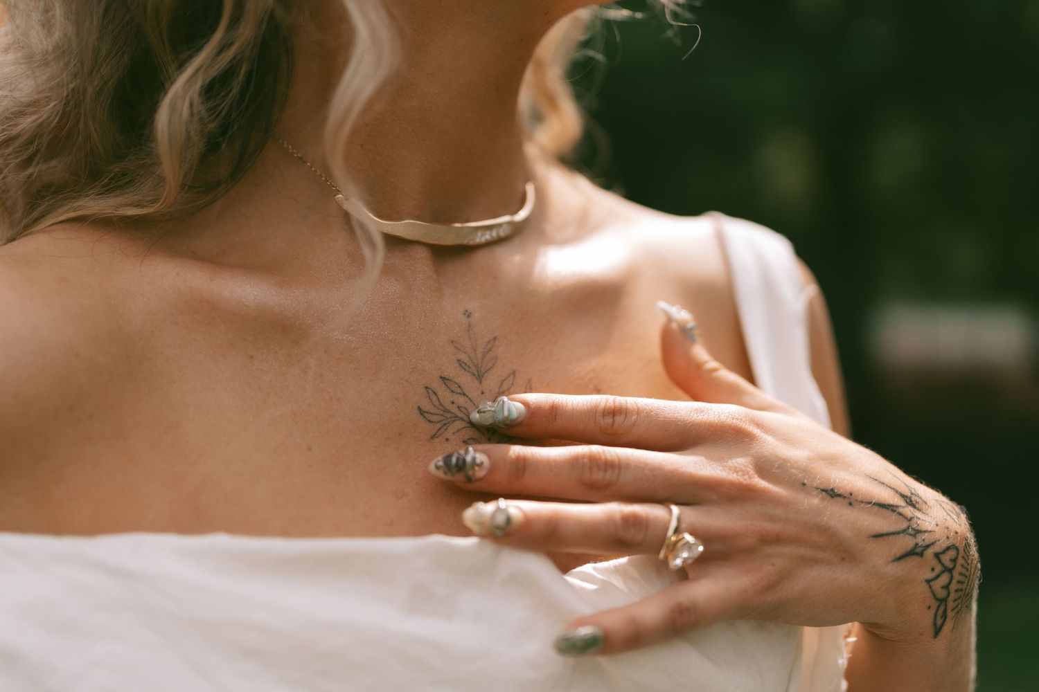 Close-up details of wedding attire and jewelry in warm lighting.