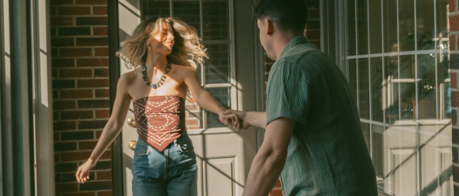 People playfully moving along brick walls in a candid photo sequence.