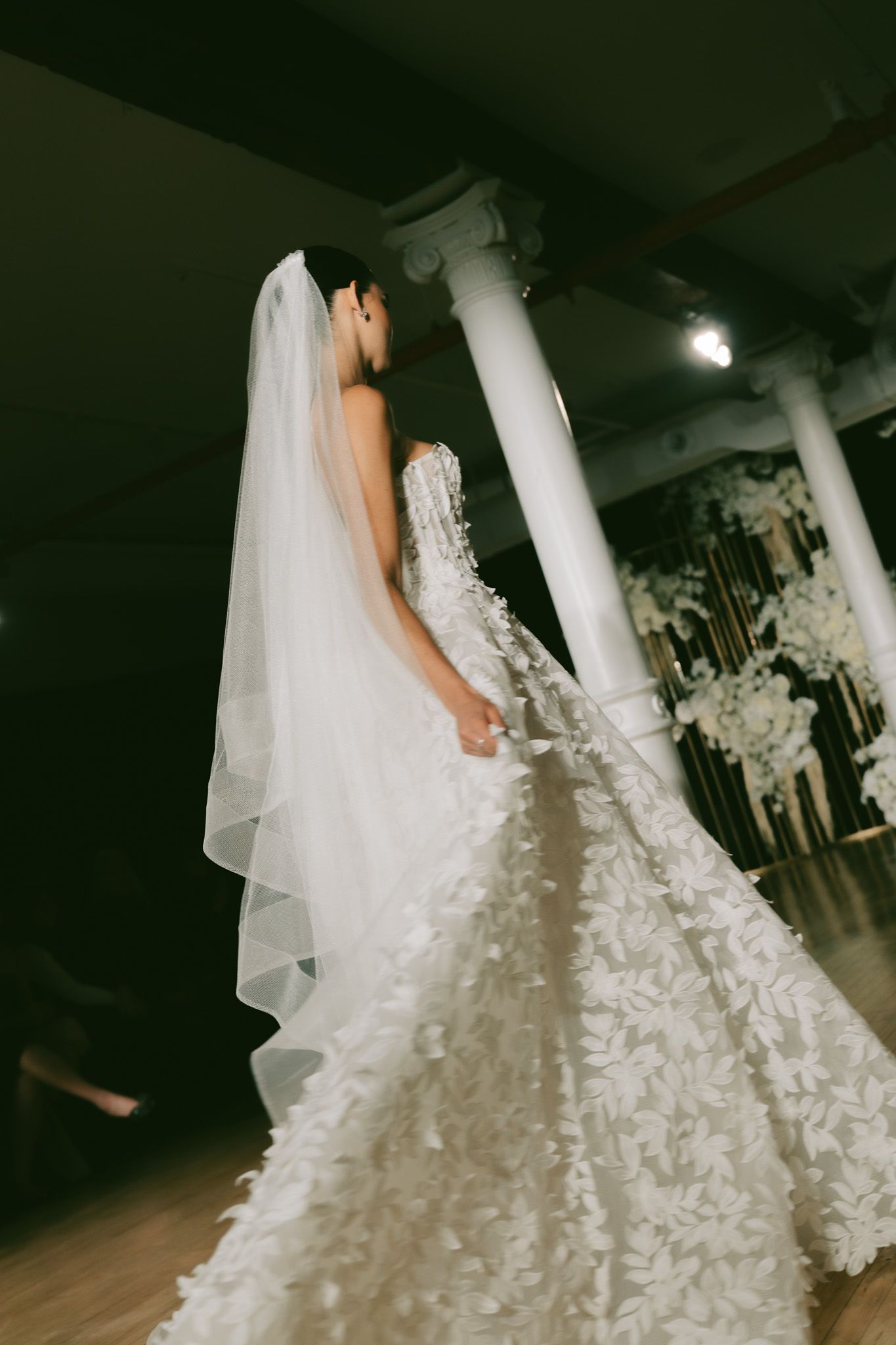 Berta Wedding dress with dramatic train and floral details photographed in moody studio lighting in NYC.