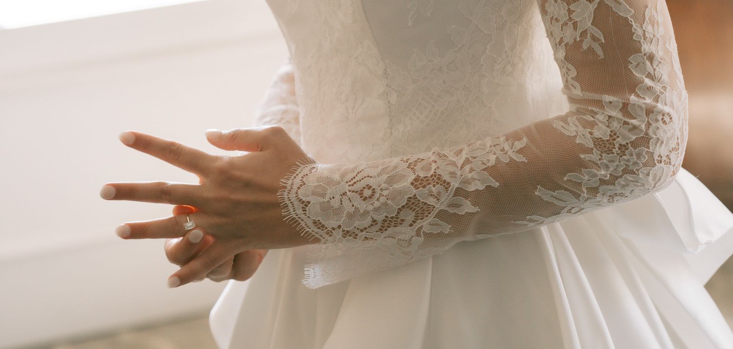 Close-up details of a lace wedding dress bodice in natural light in downtown pittsburgh, pa..