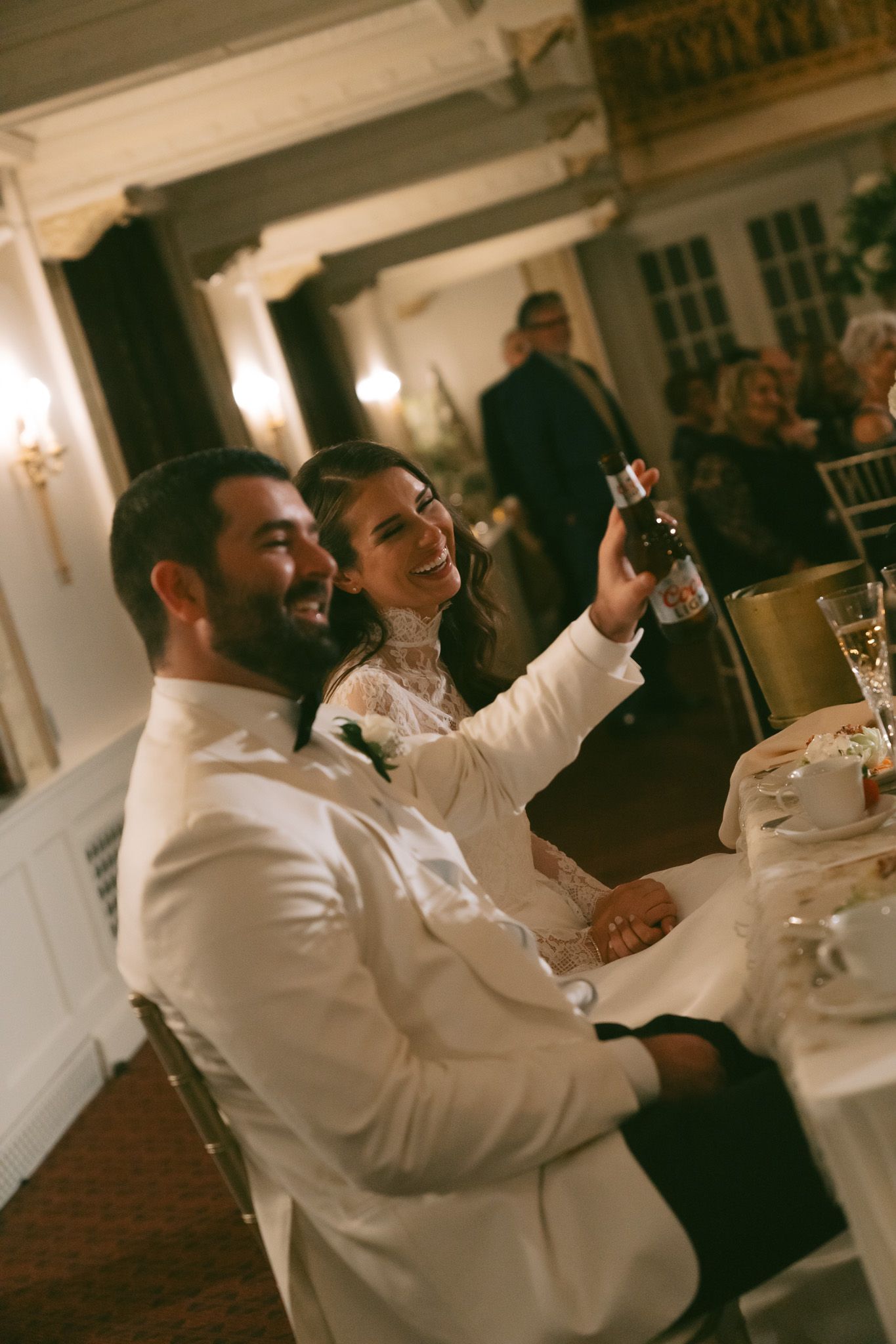 Wedding couple celebrating at a reception dinner with joyful toasts and laughter in downtown pittsburgh, pa.