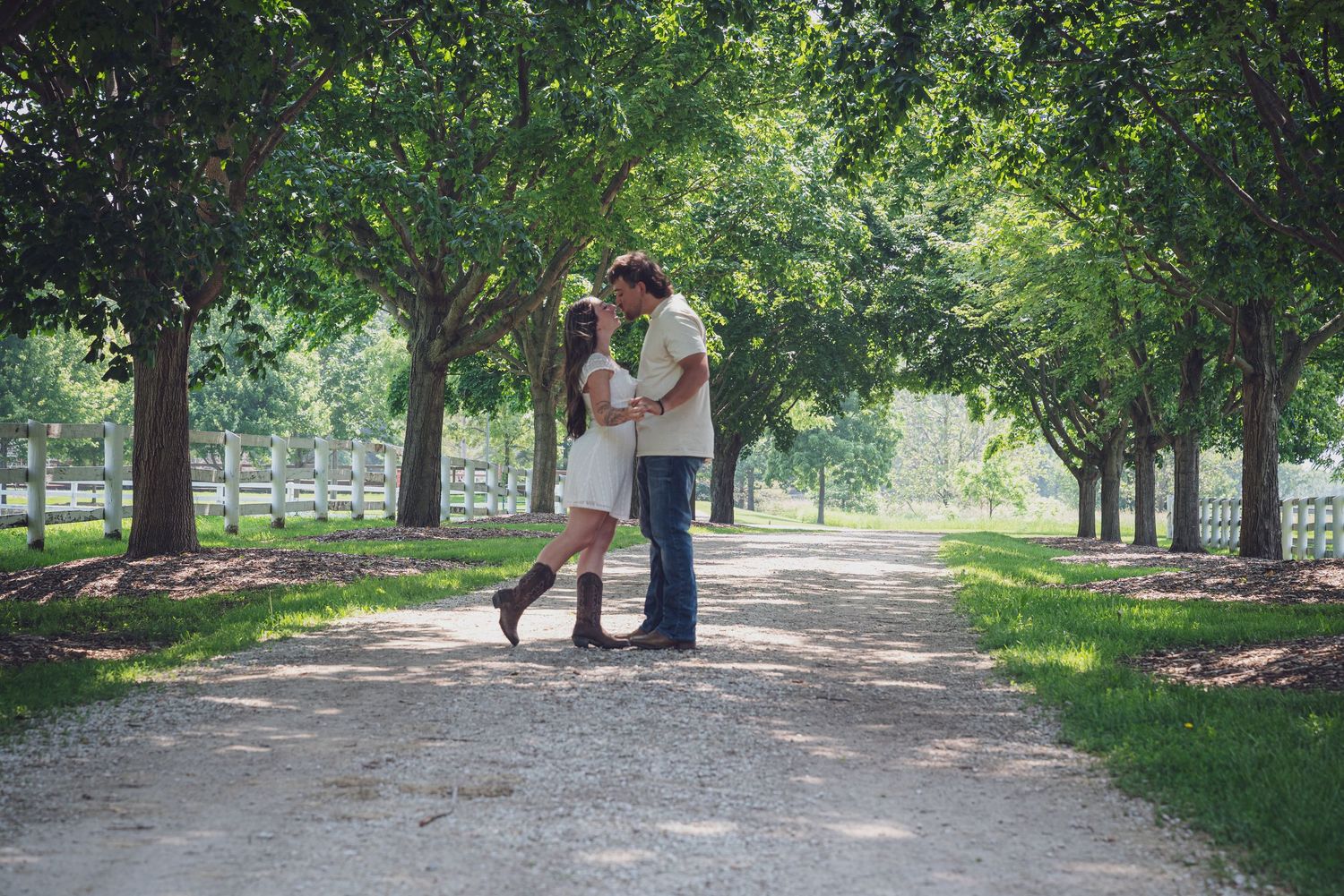 Couple embracing on a tree-lined path in a romantic outdoor setting. goose.img photography LLC - Chicago Photographer