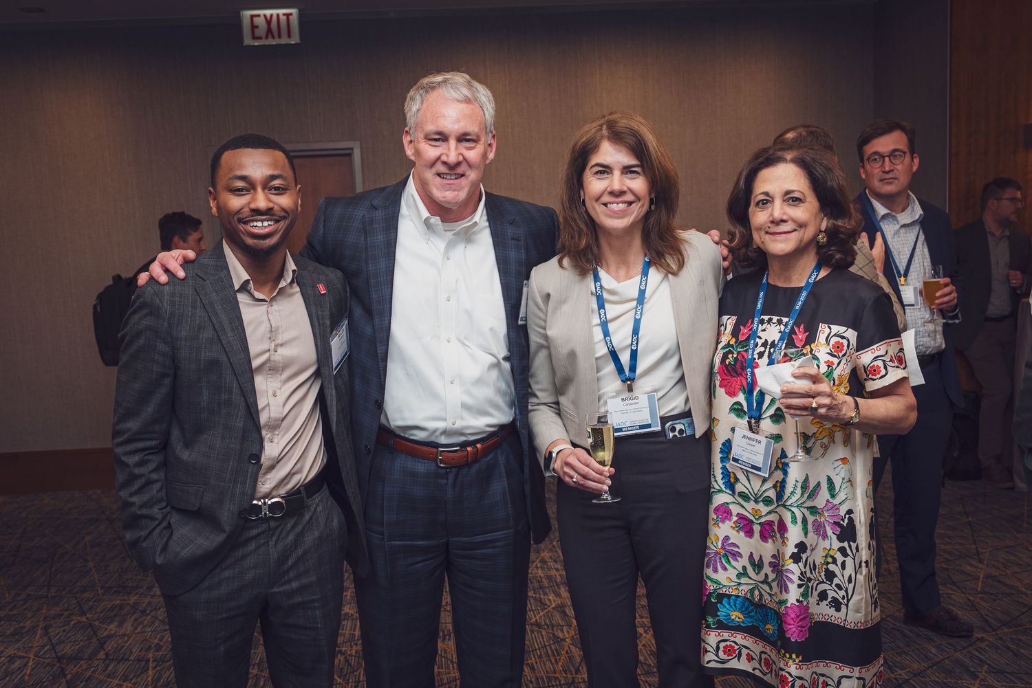 Group of people socializing and networking at a professional conference or business event.