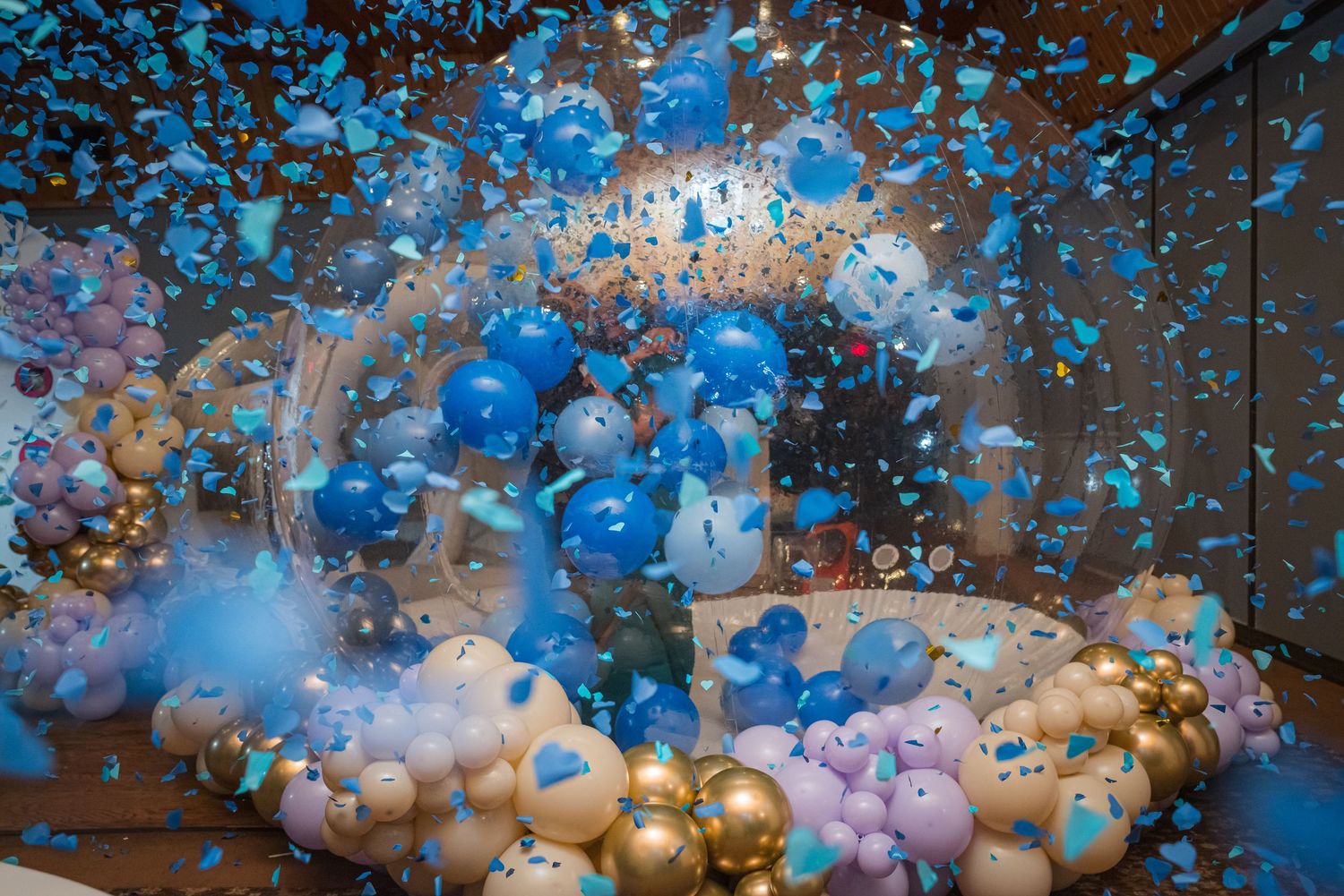 Colorful balloon arch installation with blue and gold balloons creating a festive atmosphere.