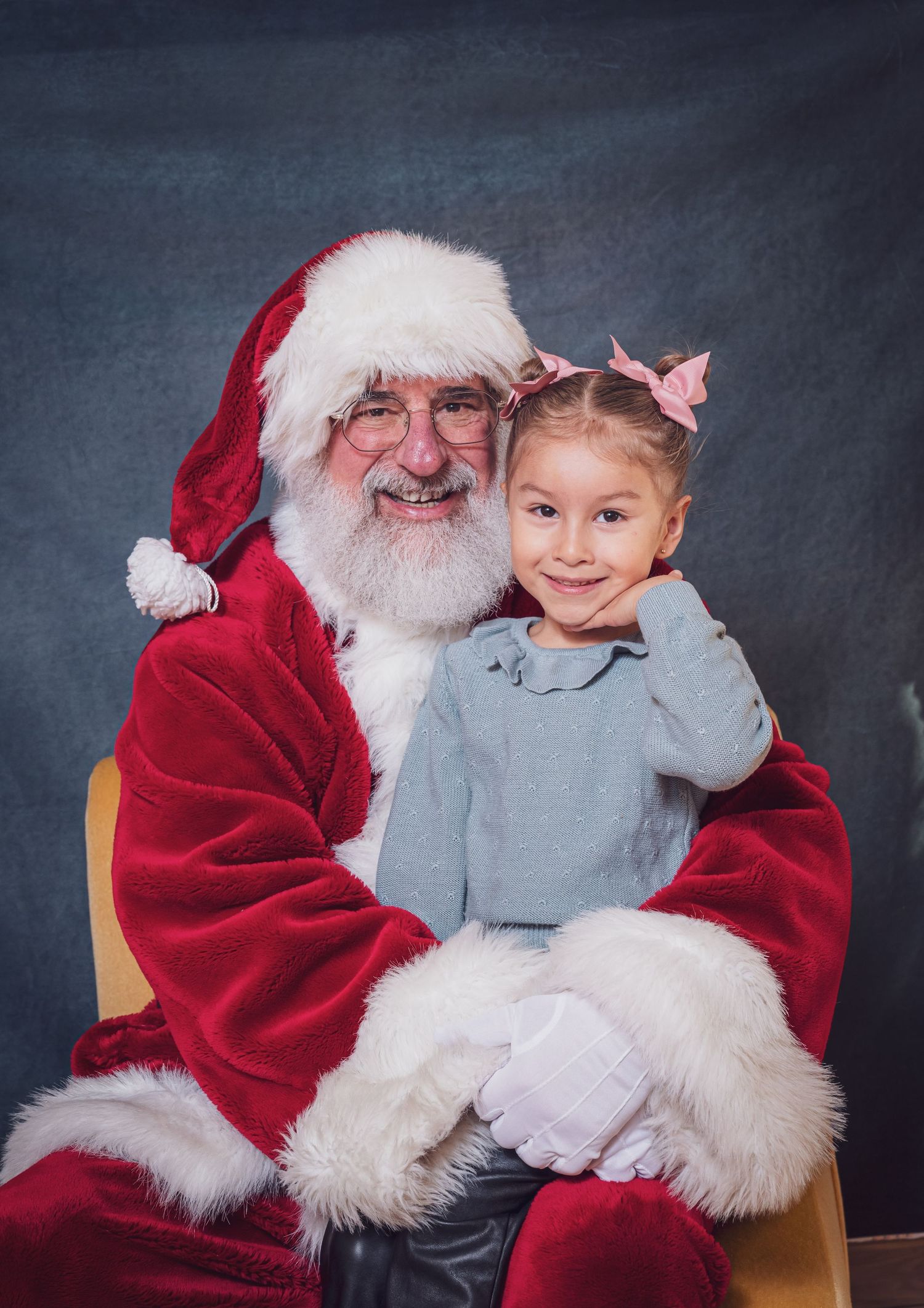 Child visiting with traditional Santa Clause in studio portrait setting. Photography by goose.img photography LLC - Chicago Photographer