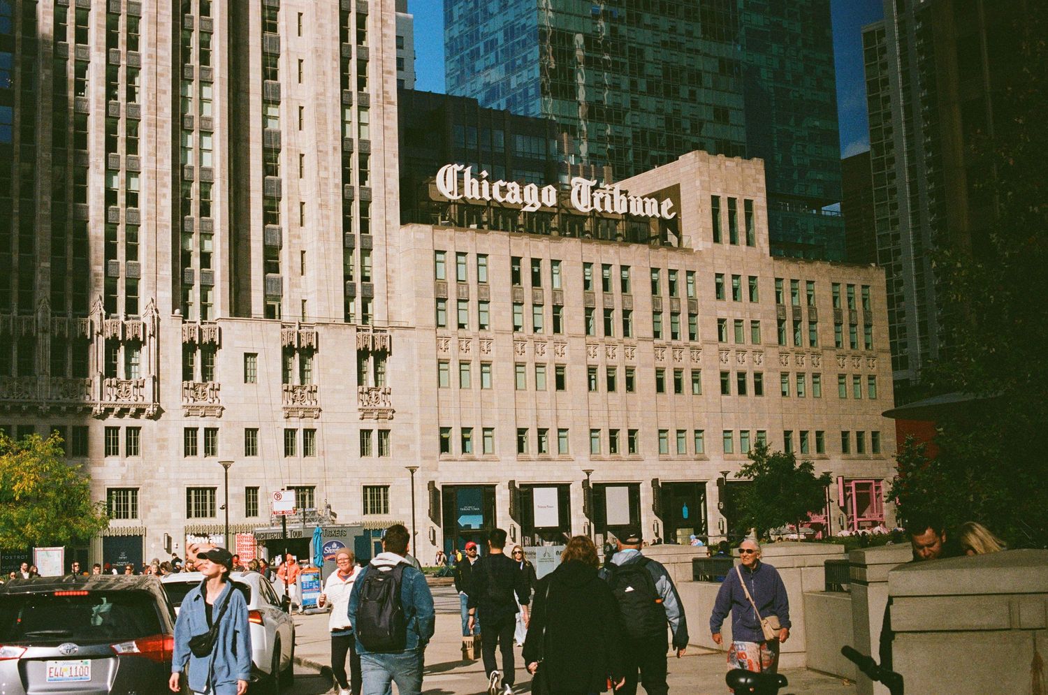 Historic Chicago Tribune building exterior with people walking on the street.