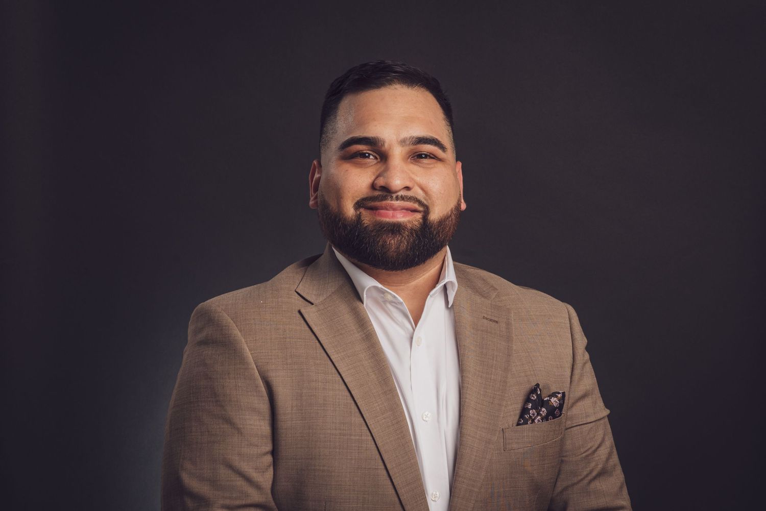 A professional headshot of someone in a brown suit jacket with a pocket square. goose.img photography LLC - Chicago Photographer