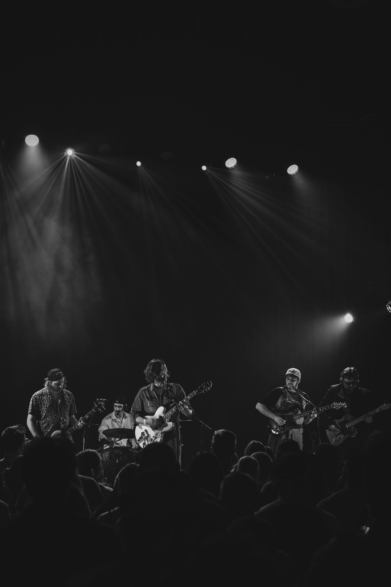 Black and white concert photo showing band performing under dramatic stage lighting. goose.img photography LLC - Chicago Photographer