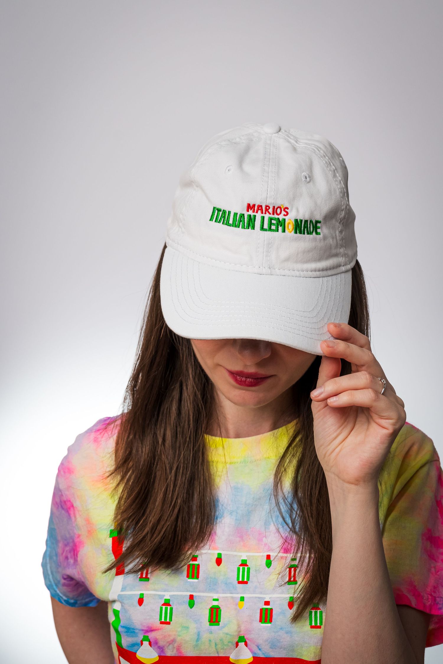 A close-up shot of someone wearing a white Italian ice branded cap and tie-dye t-shirt. goose.img photography LLC - Chicago Photographer