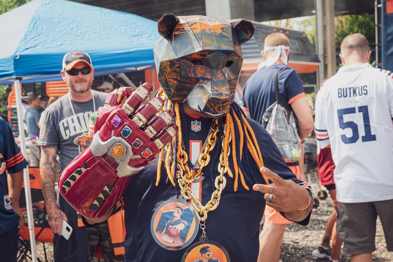 Sports fan in colorful outfit and chains tailgating at outdoor event. goose.img photography LLC - Chicago Photographer