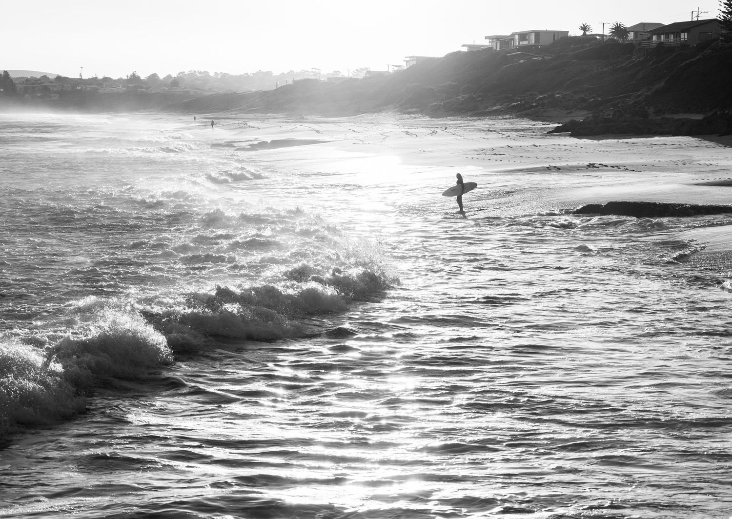 Black and white image of surfer on Knights Beach, Port Elliot, Fleurieu Peninsula