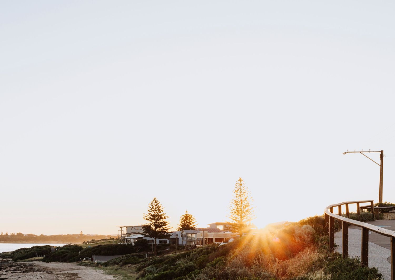 photo of sun flare created by setting sun over Middleton, South Australia