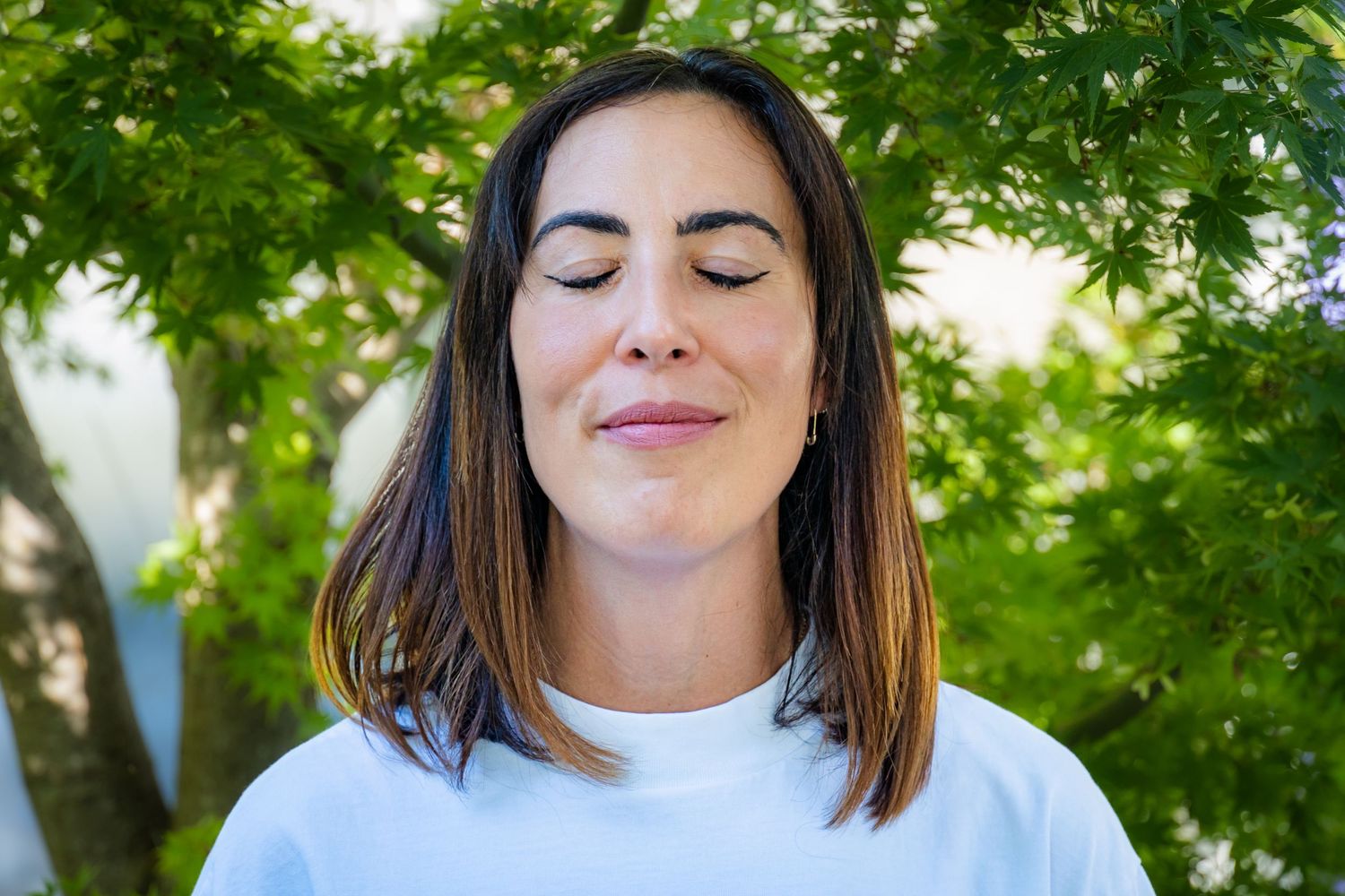 Professional headshot photograph of a woman outside with trees behind her in California by Don Wilson