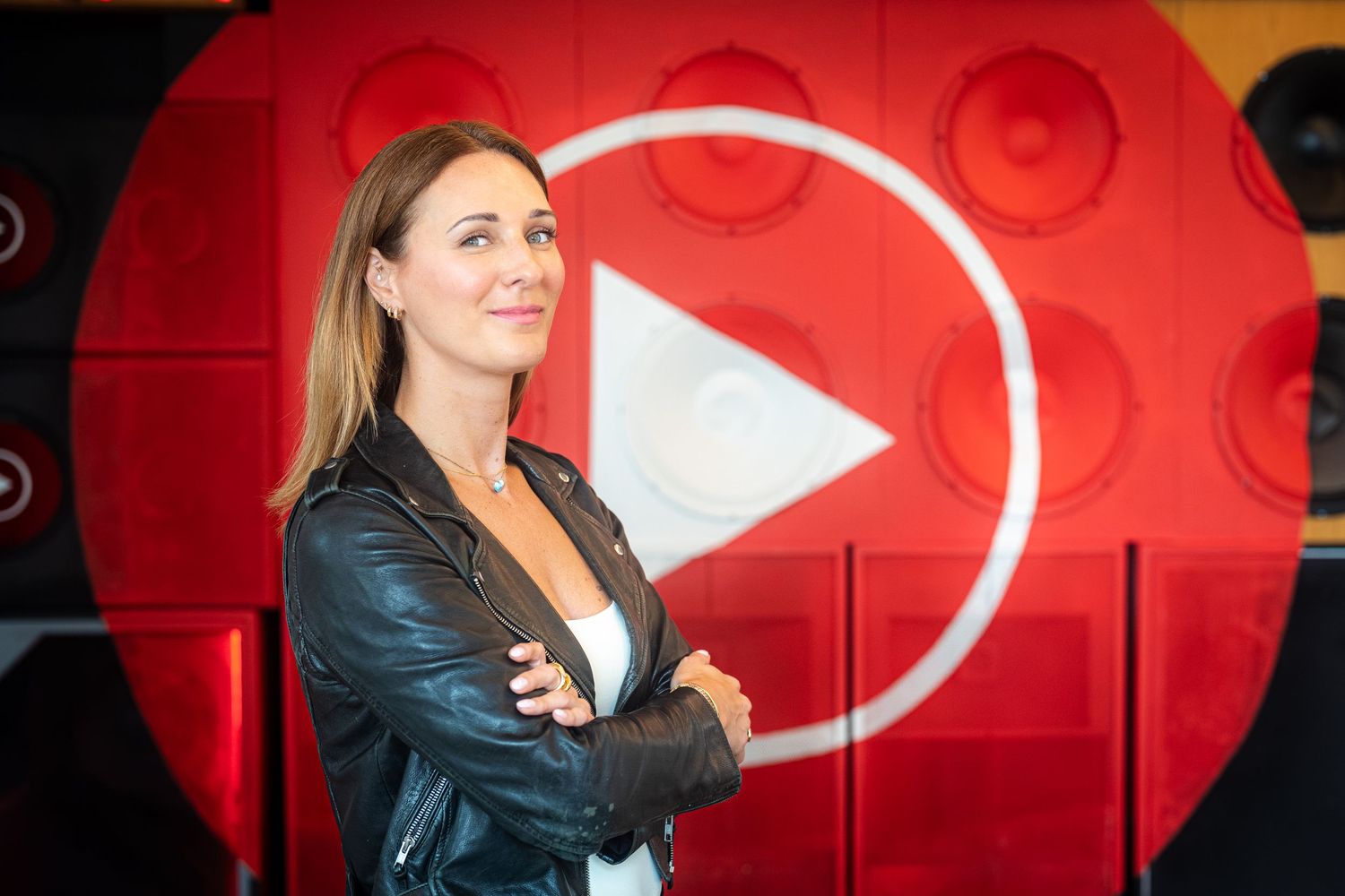 Professional photograph of a businesswoman sitting in front of a YouTube logo shot by Create With Don in NYC