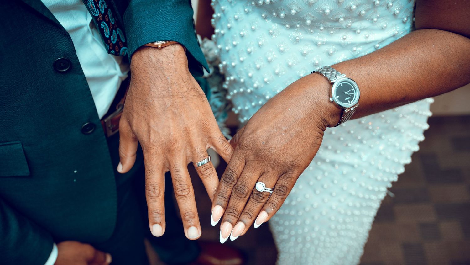 Close-up shots of wedding rings and hands showing intricate details of bridal jewelry.