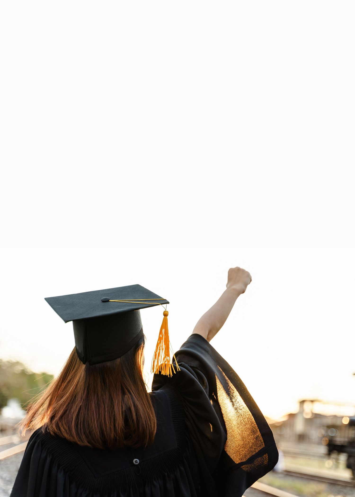 Graduates raise their caps in celebration during commencement ceremony.