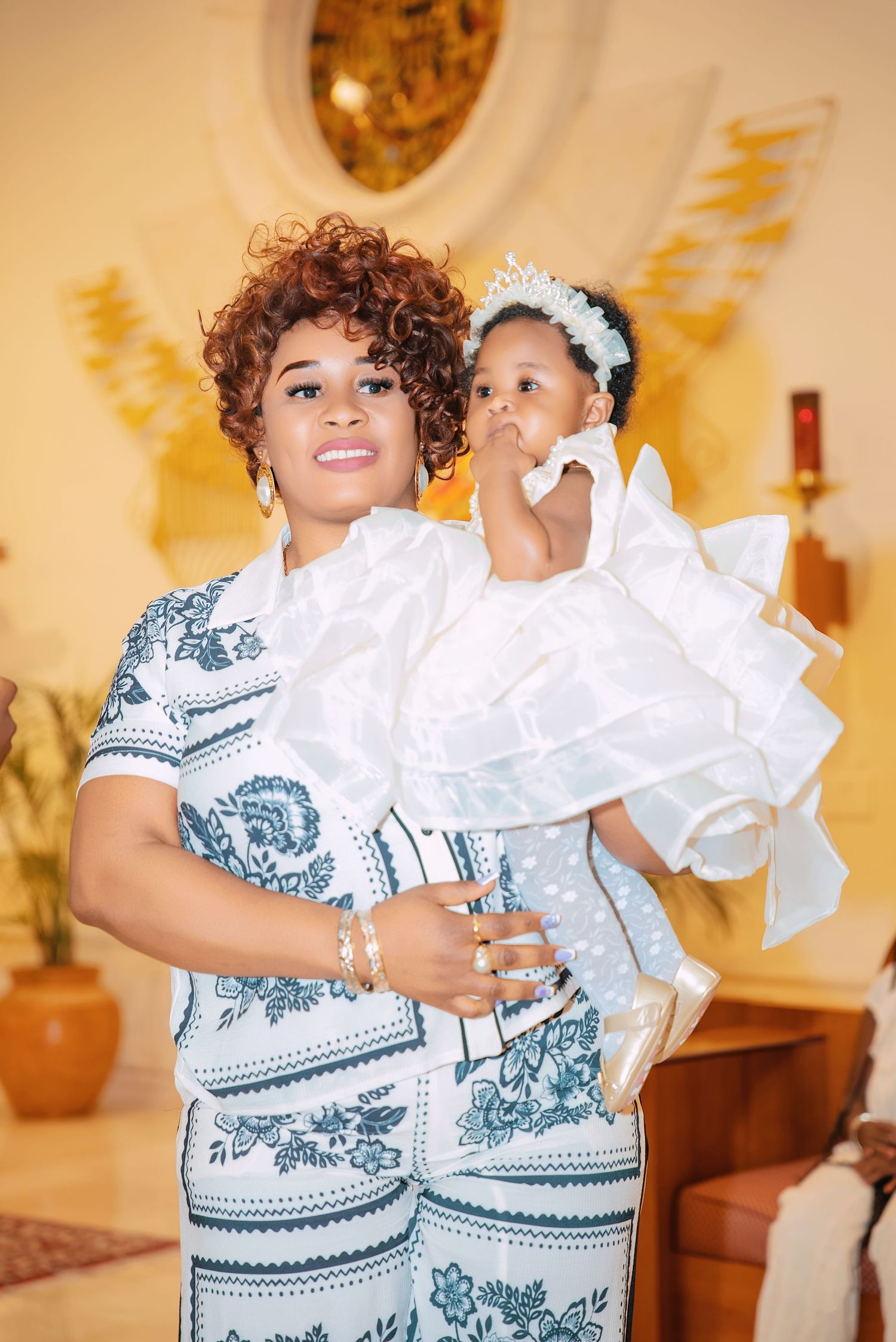 Parent and child in coordinating blue and white outfits at a formal event.