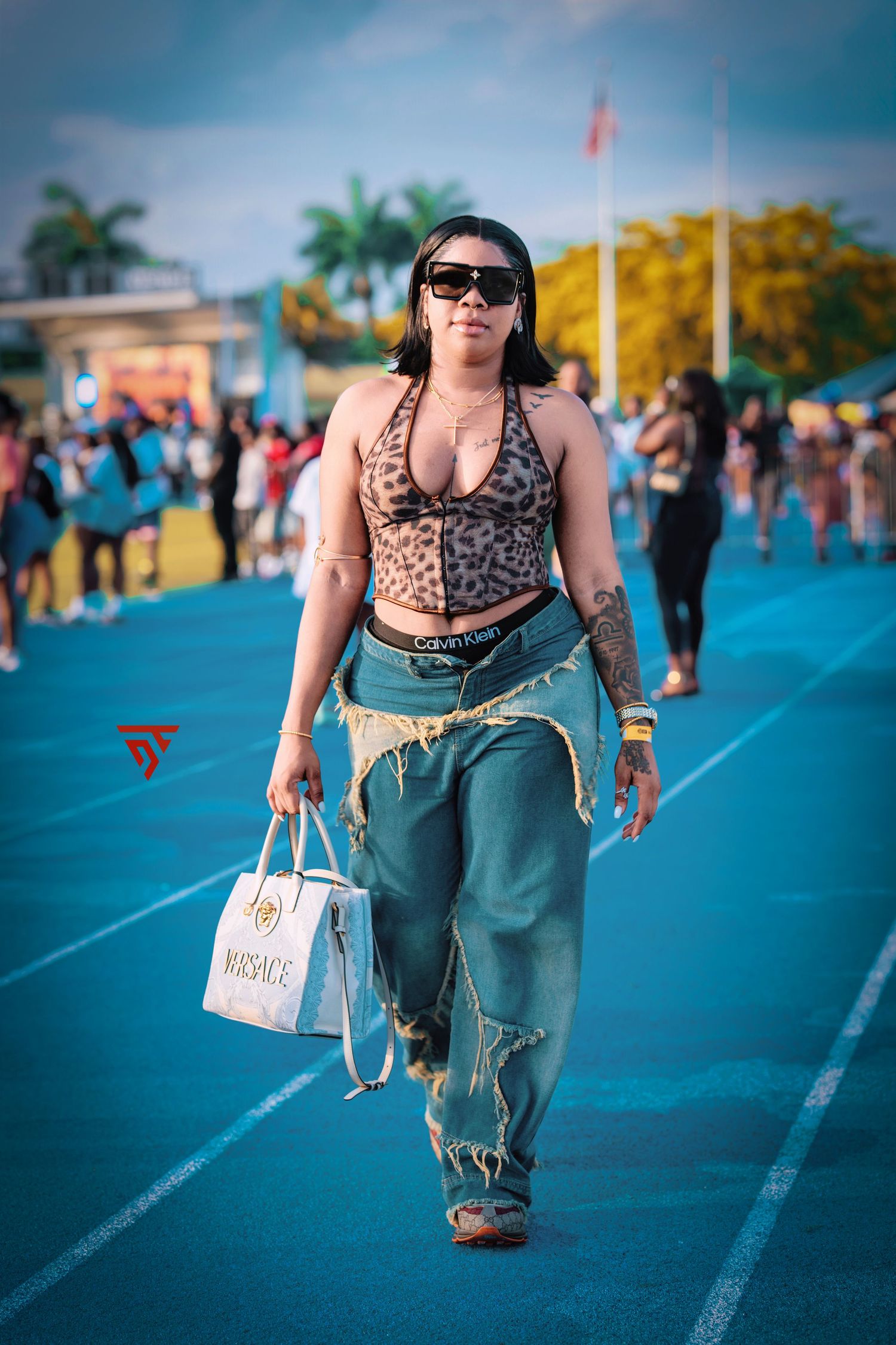 Casual street style photography on a blue walkway during a sunny day.