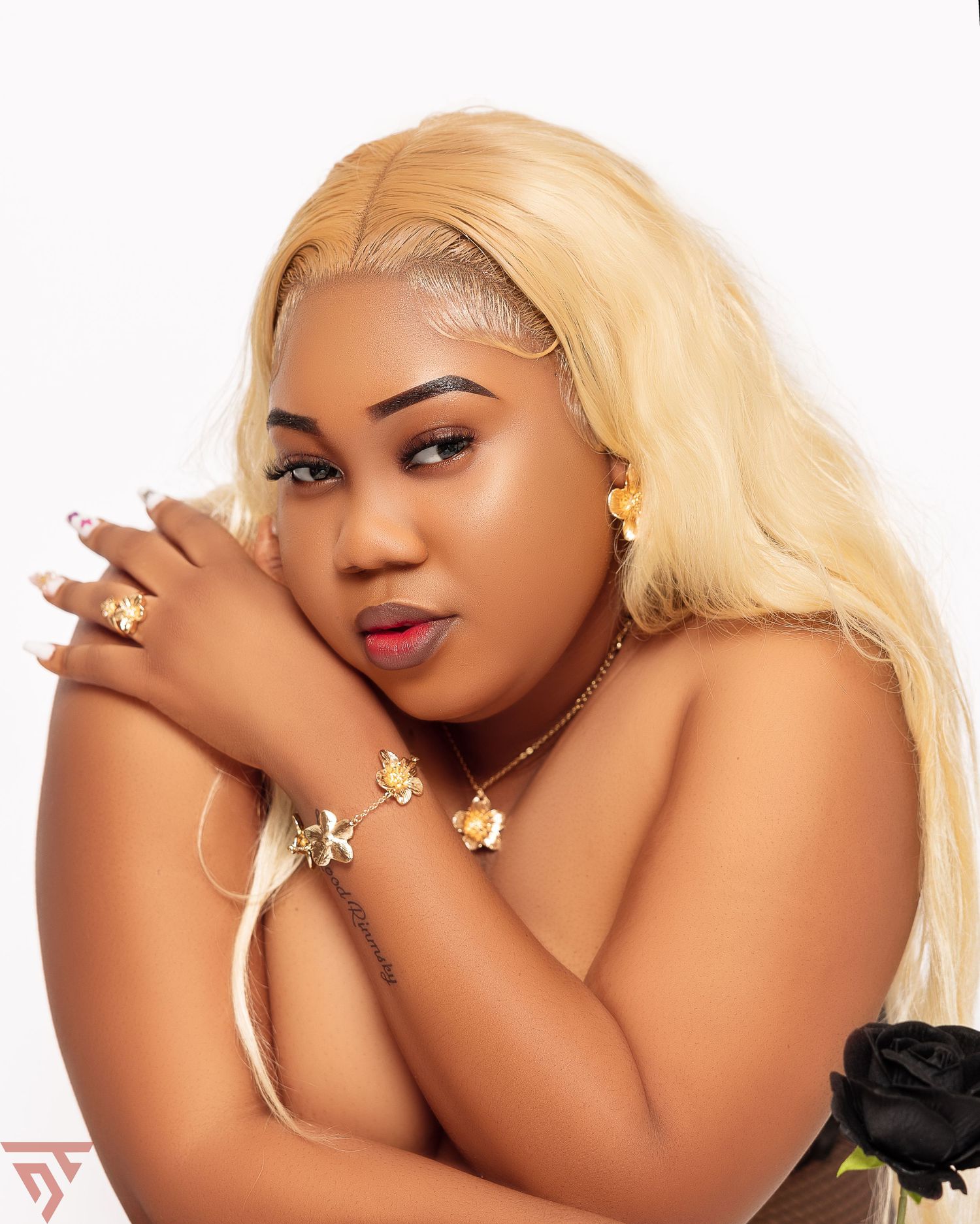 Artistic beauty portrait with blonde hair and gold jewelry.