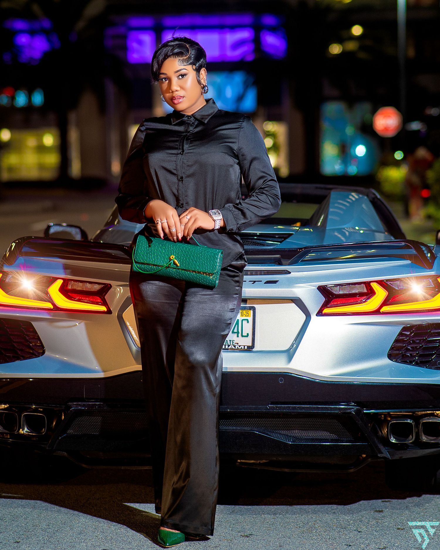 Modern sports car with distinctive rear lighting displayed in dark urban setting.