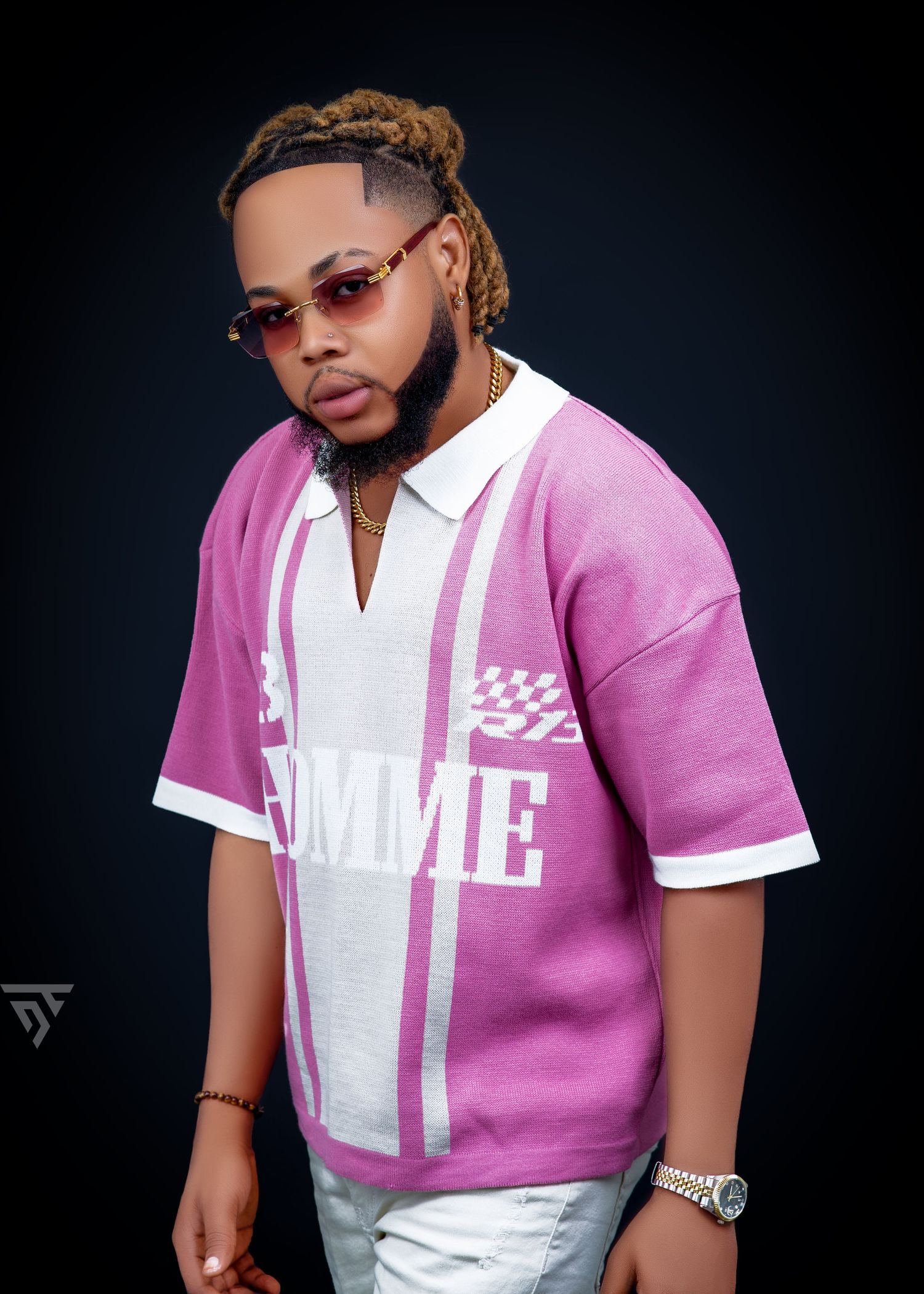Stylish portrait featuring a pink and white sports-style jersey with sunglasses against dark background.