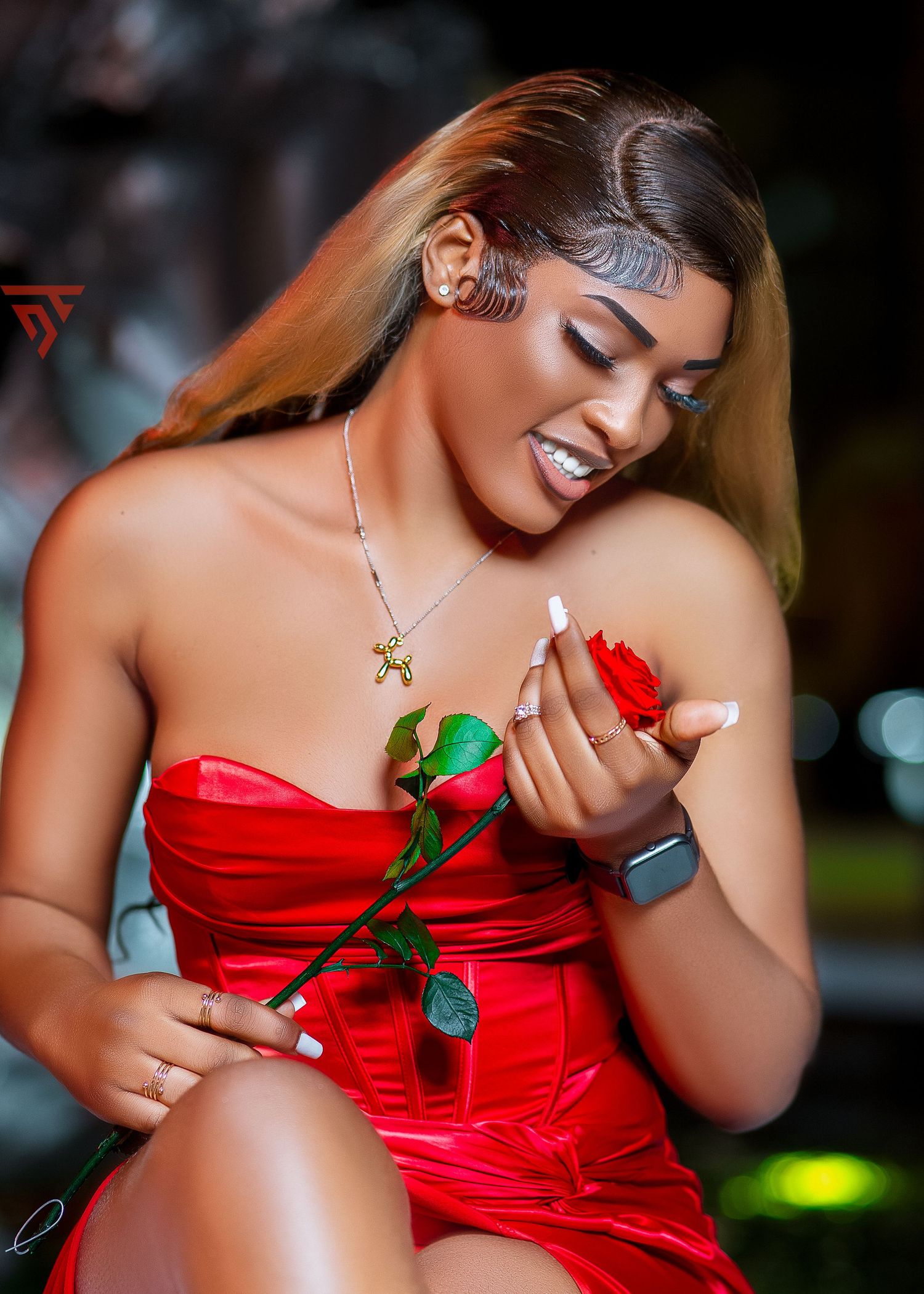 Romantic portrait session with red satin dress and single rose.