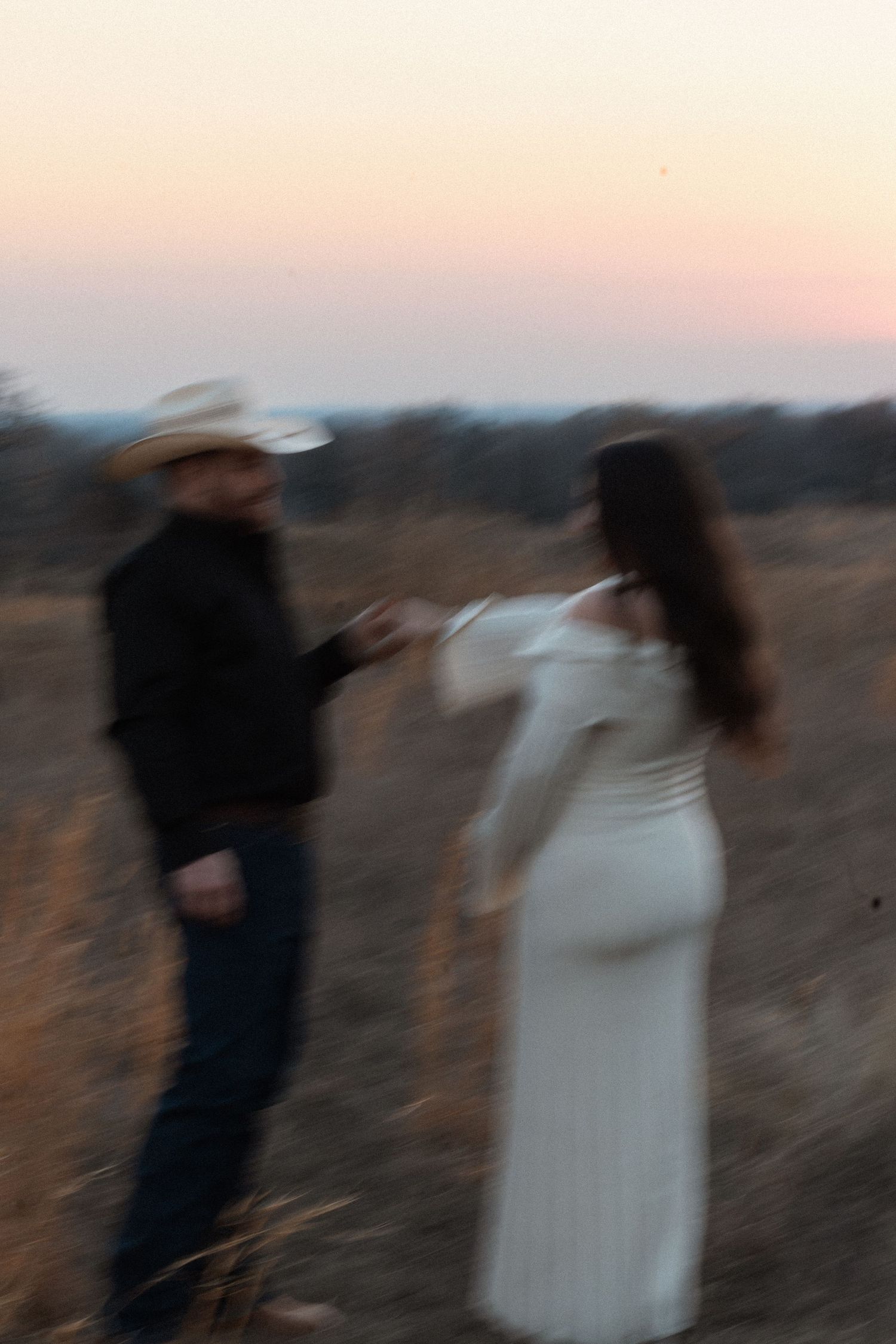 A blurred artistic photo sequence showing two figures in motion against a sunset sky, creating a dreamy effect.