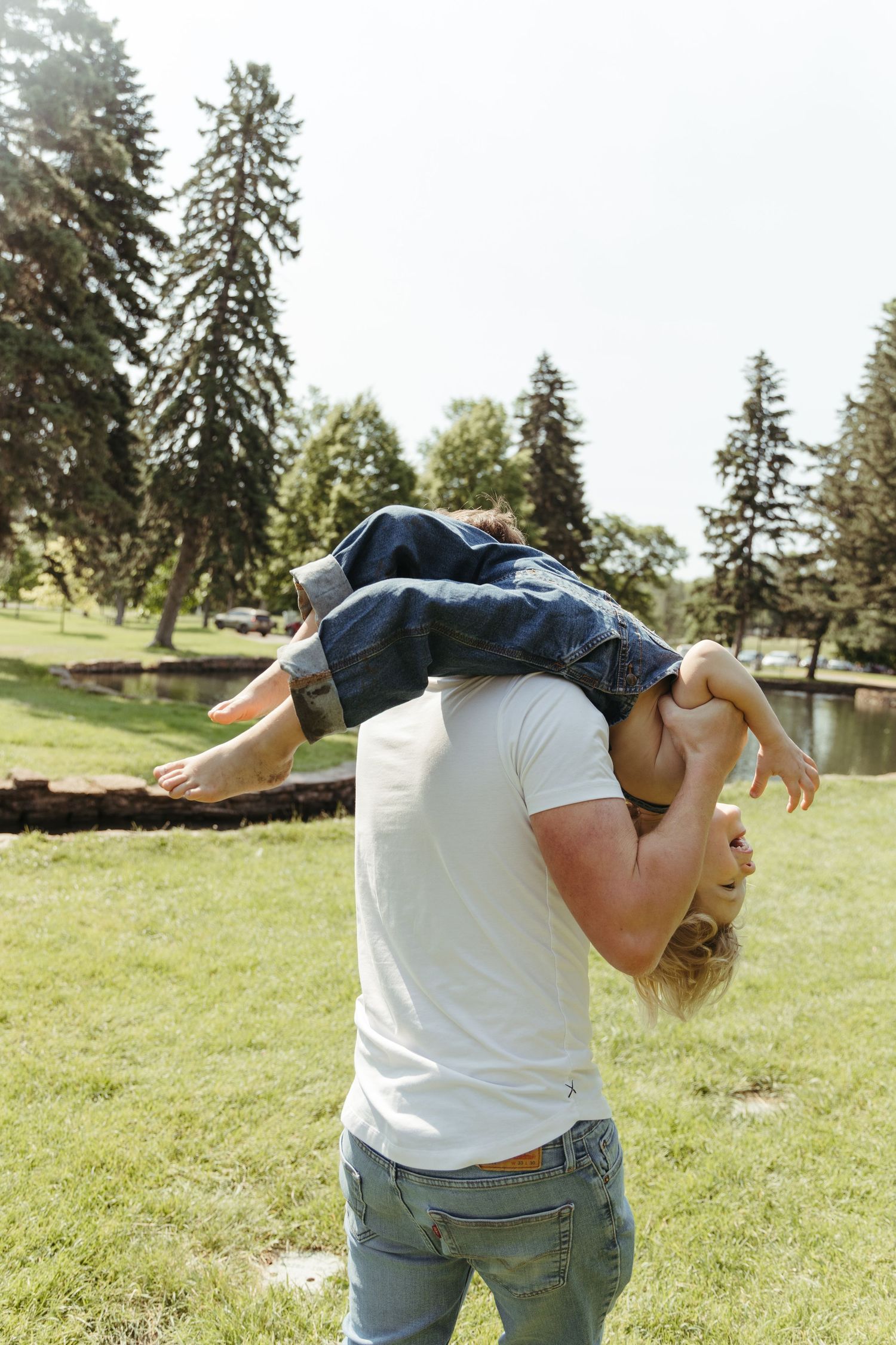 Dynamic family photography poses in a sunlit park setting.