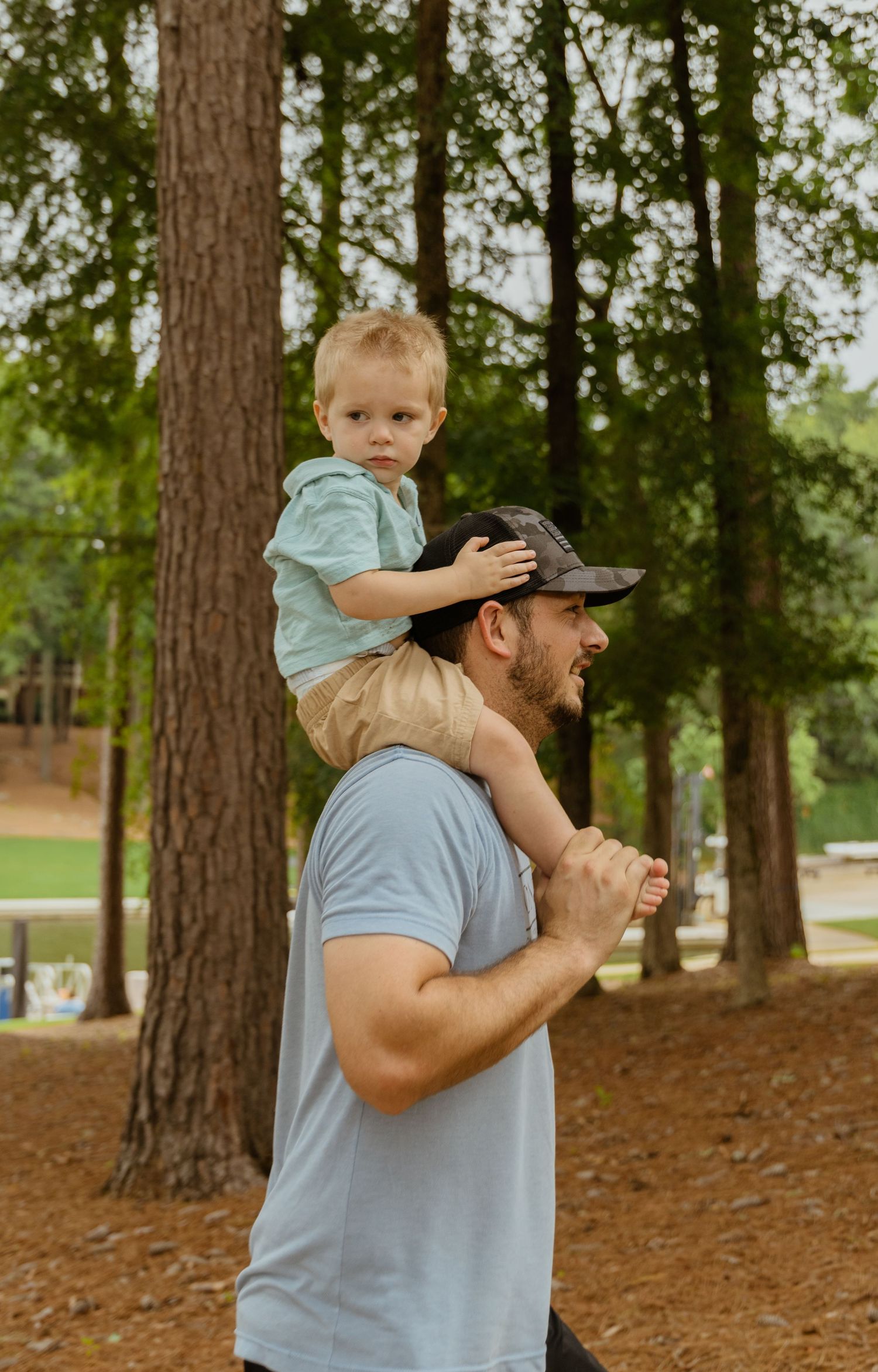 A tender moment shared between parent and child in a wooded setting.