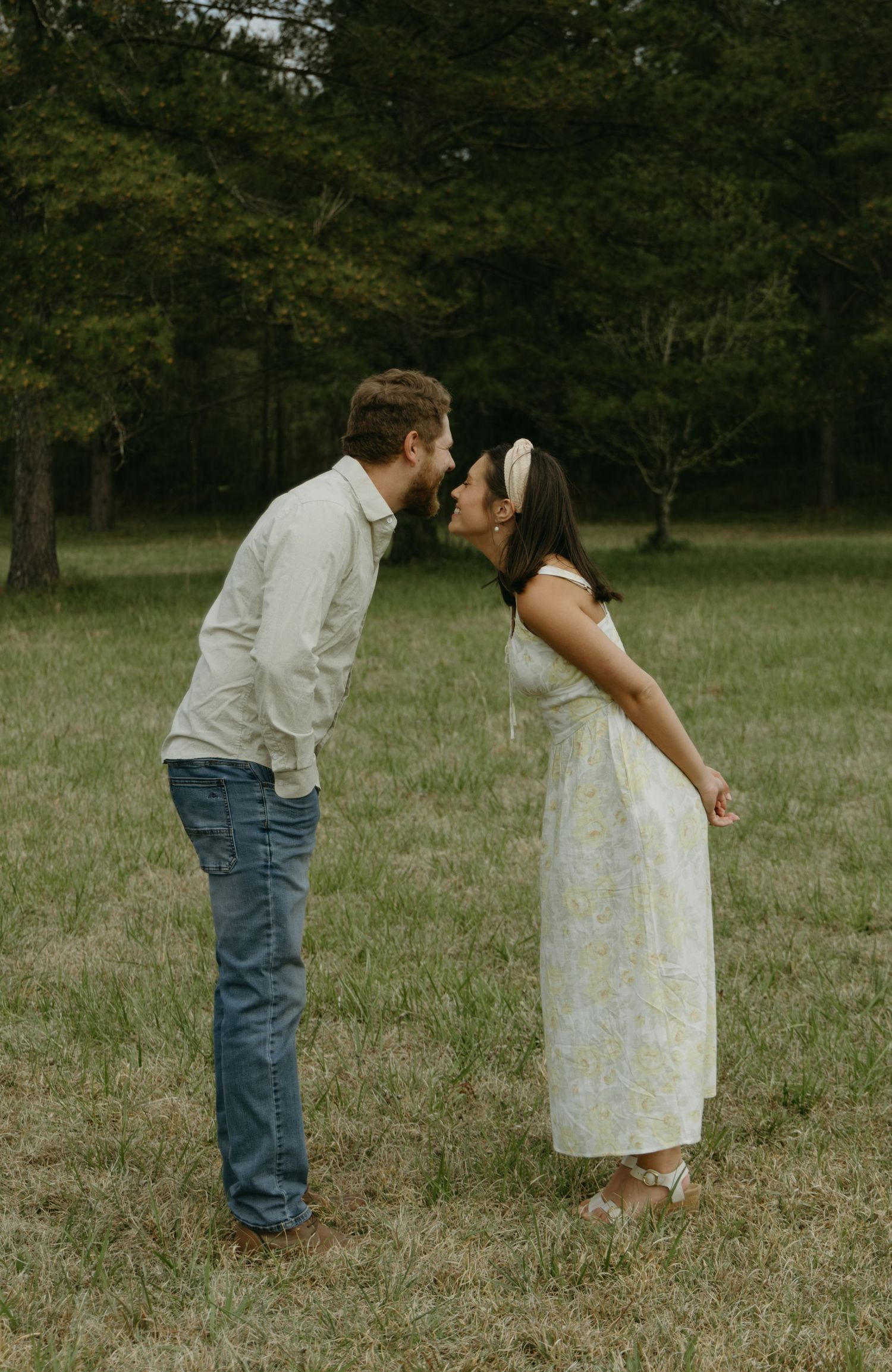 A couple leaning and trying to kiss photography pose