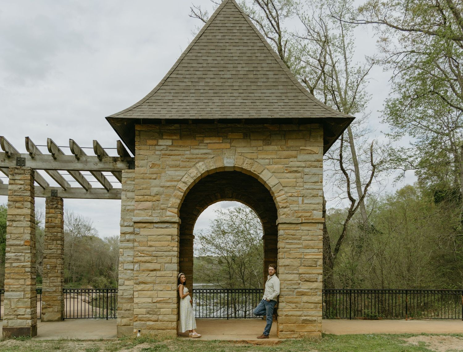 Stone archway structures in a park with rustic architectural details.