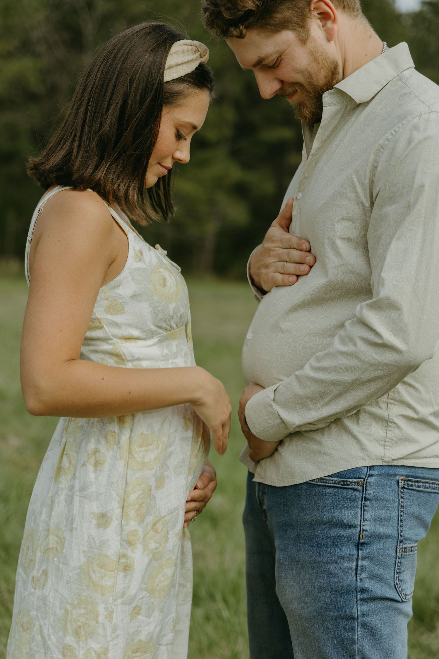 A couple embraces tenderly while looking at something special.