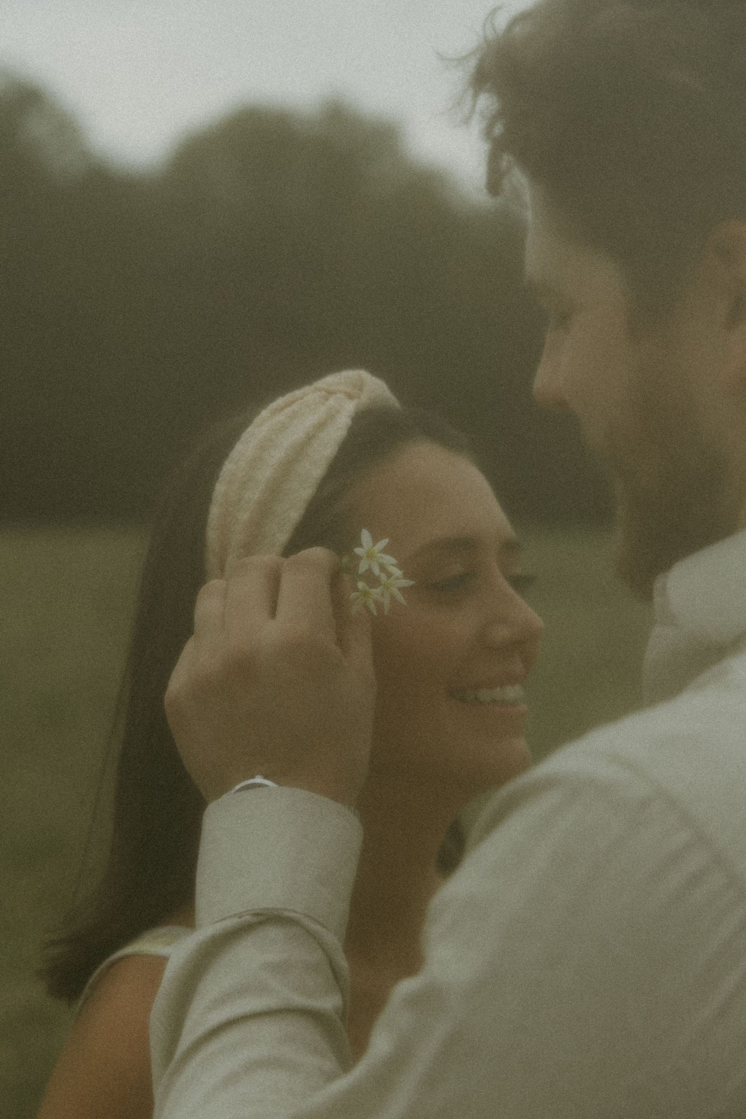 Romantic couple sharing an intimate moment outdoors during golden hour.