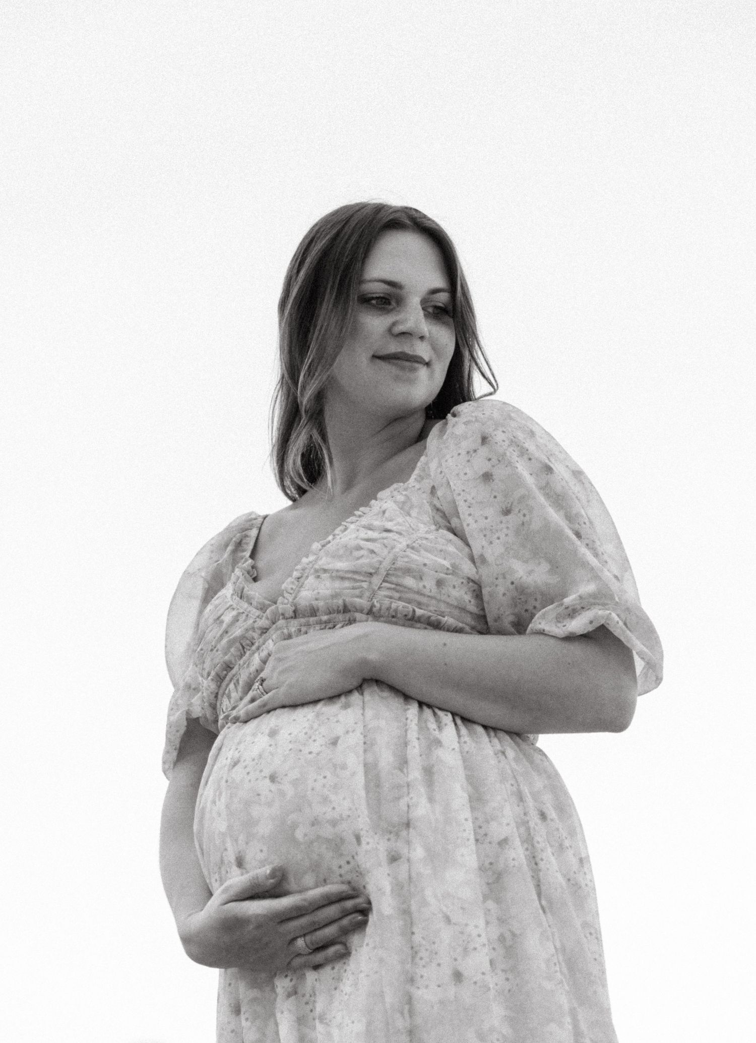 Black and white artistic maternity photography series showing a flowing dress.