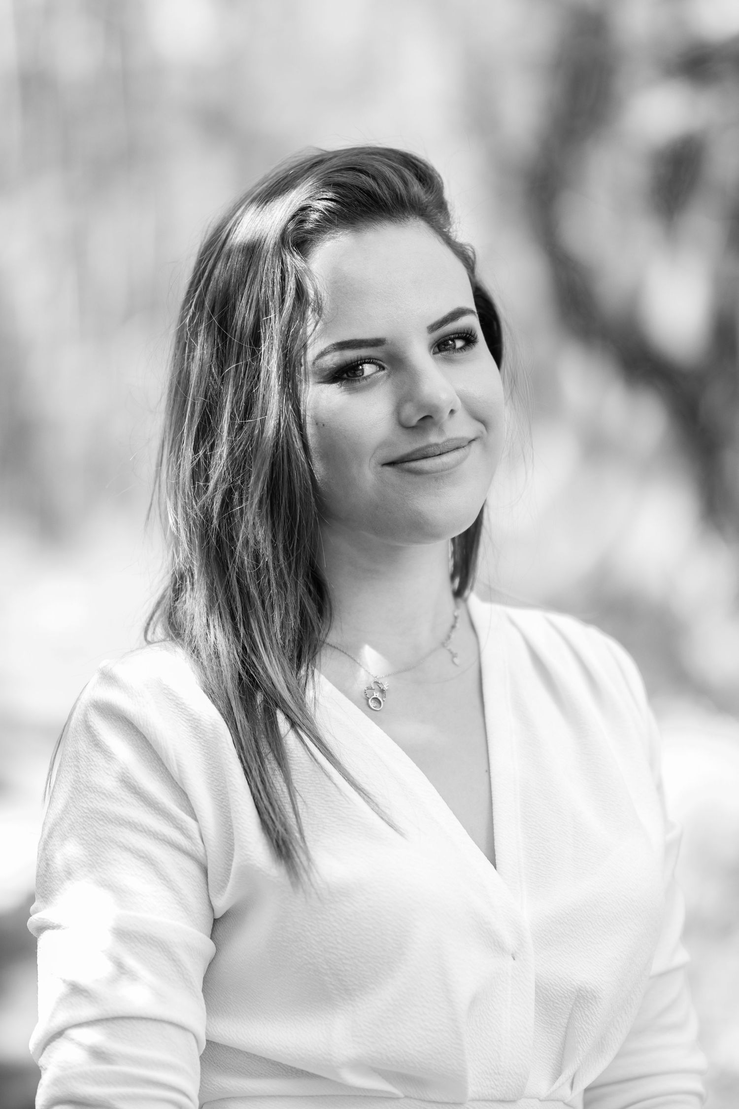 Portrait series in soft focus showing expressions against blurred natural background.