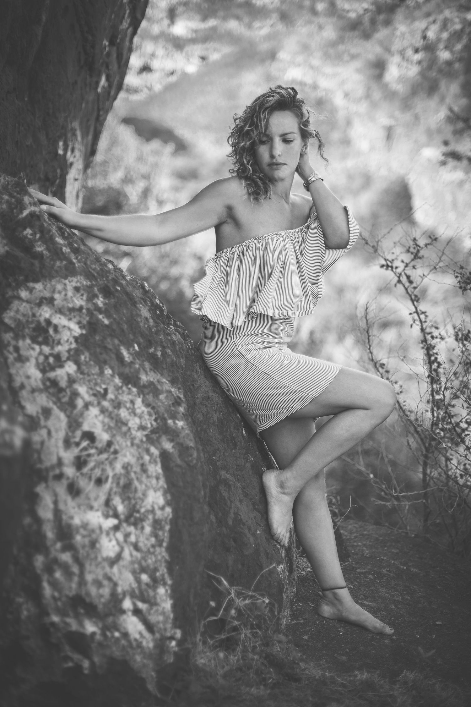 Artistic black and white photos capturing graceful poses against a natural stone backdrop.