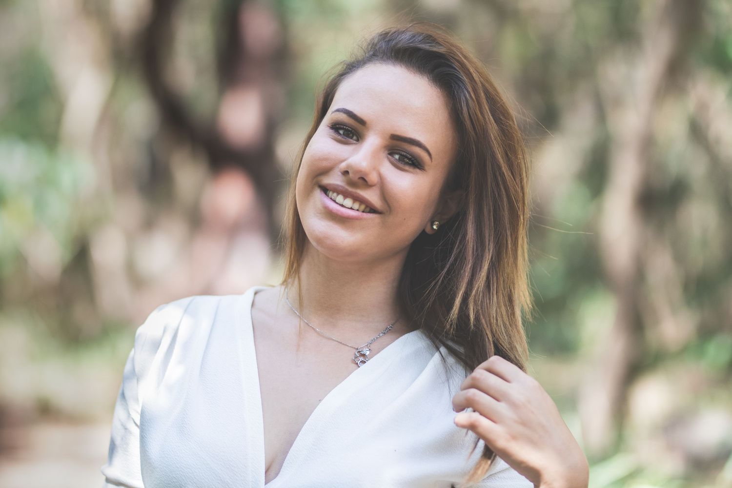 Candid lifestyle portraits taken in sunlit forest environment.