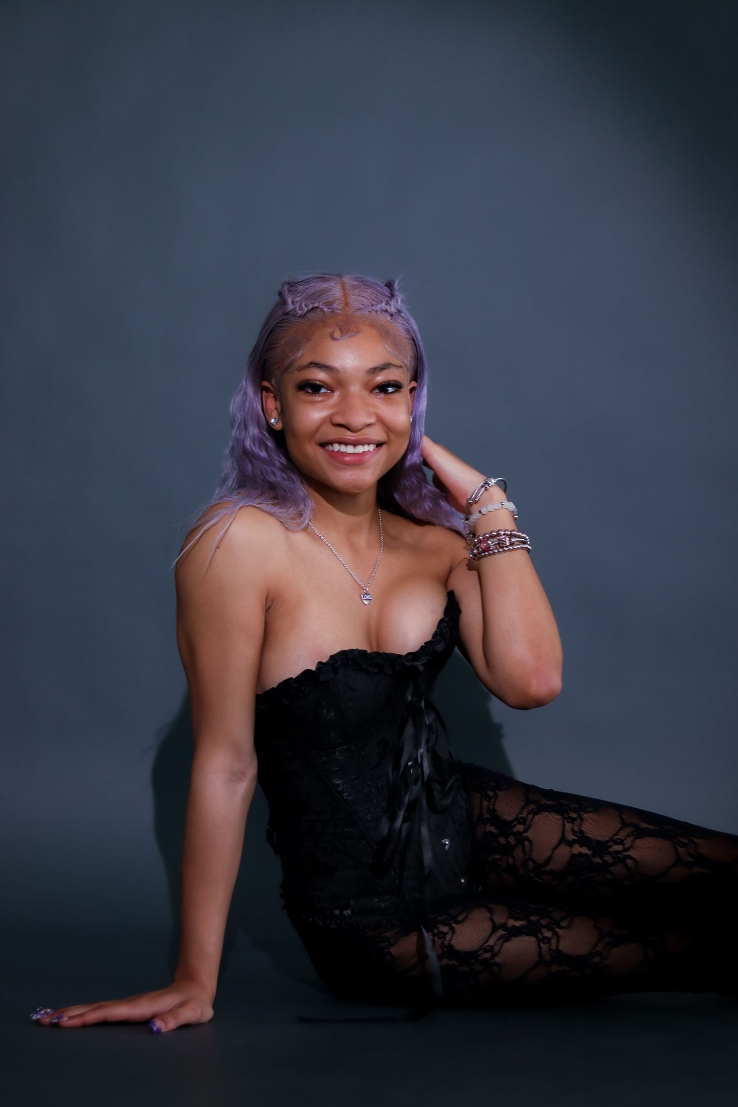 Glamour portraits in black lace dress against dark studio background.