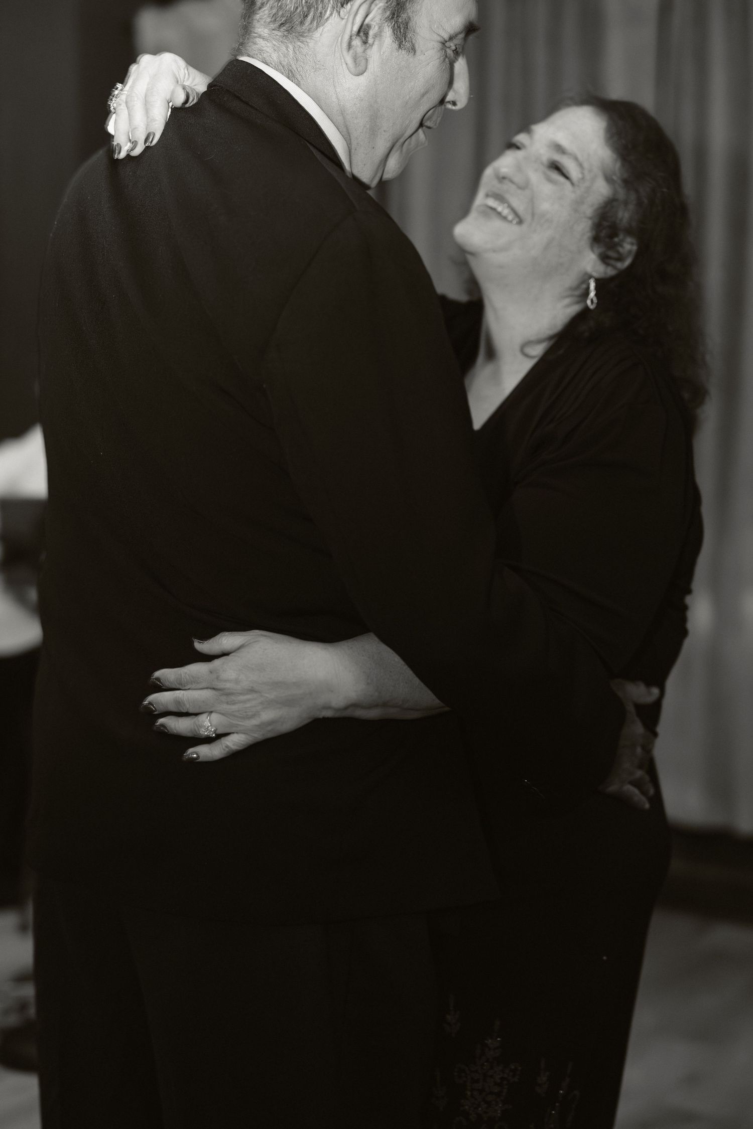 A series of black and white photos showing two people dancing together in an intimate embrace with joyful expressions.